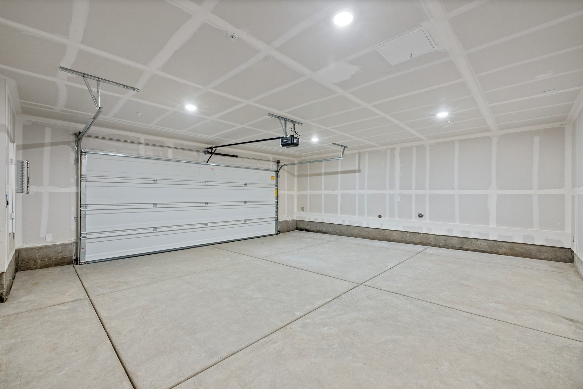 interior of spacious two-car garage with recessed ceiling lights