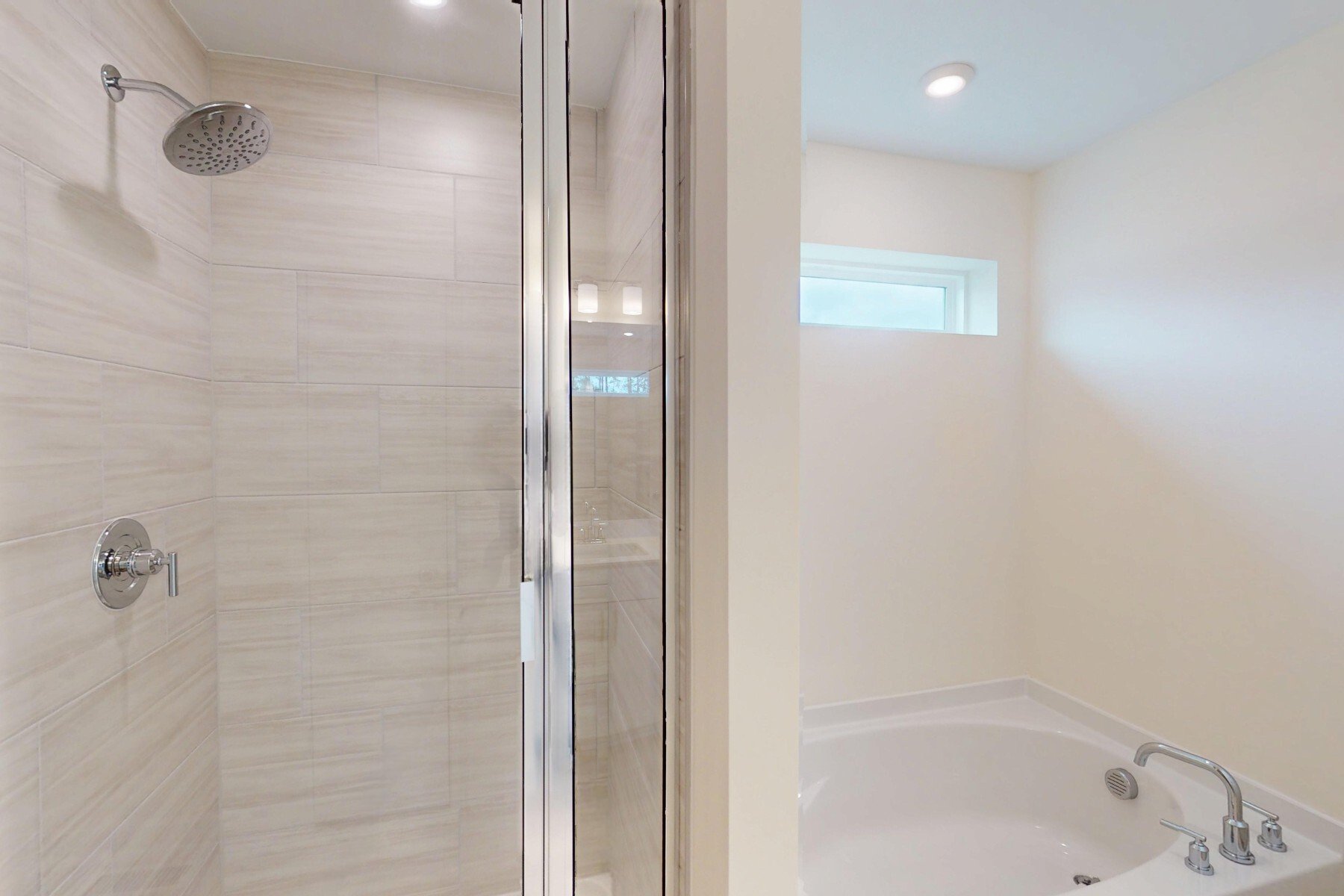 primary bathroom with separate tub and shower