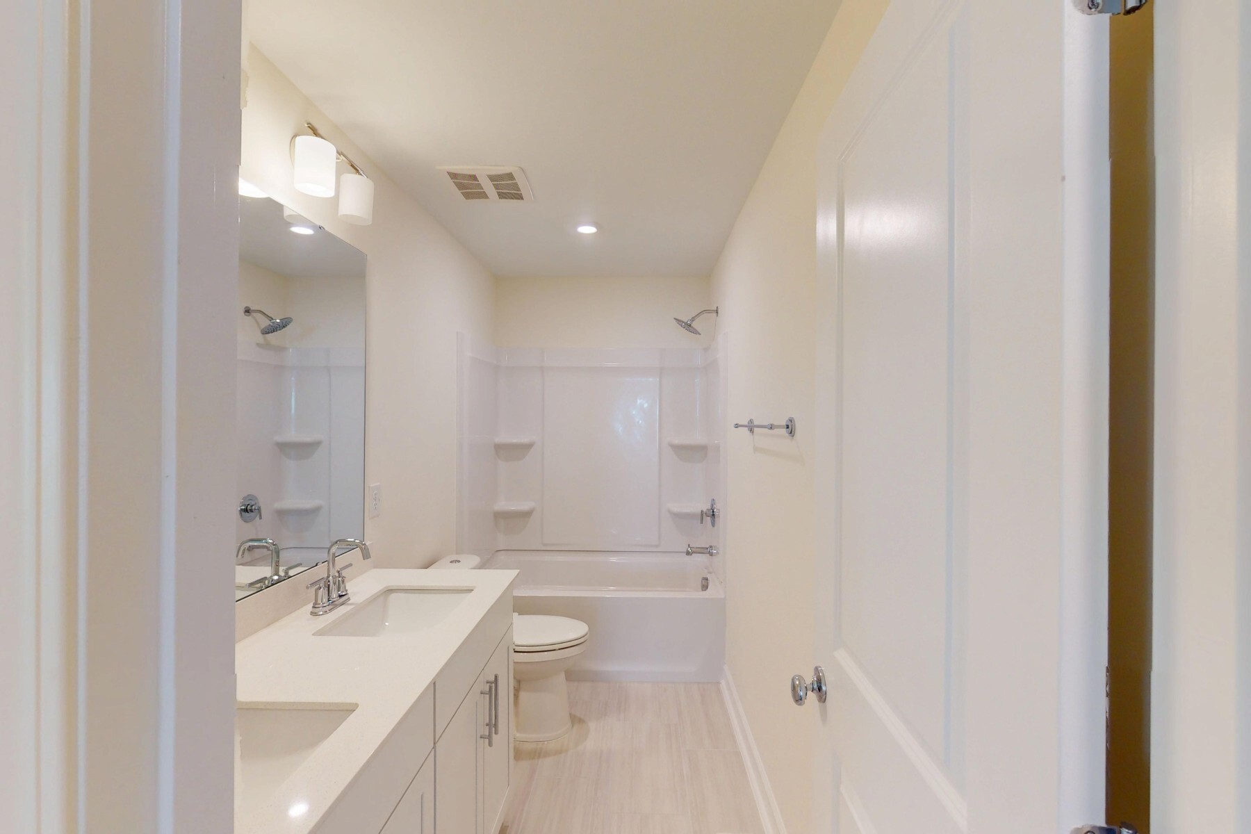 secondary bathroom with two sinks