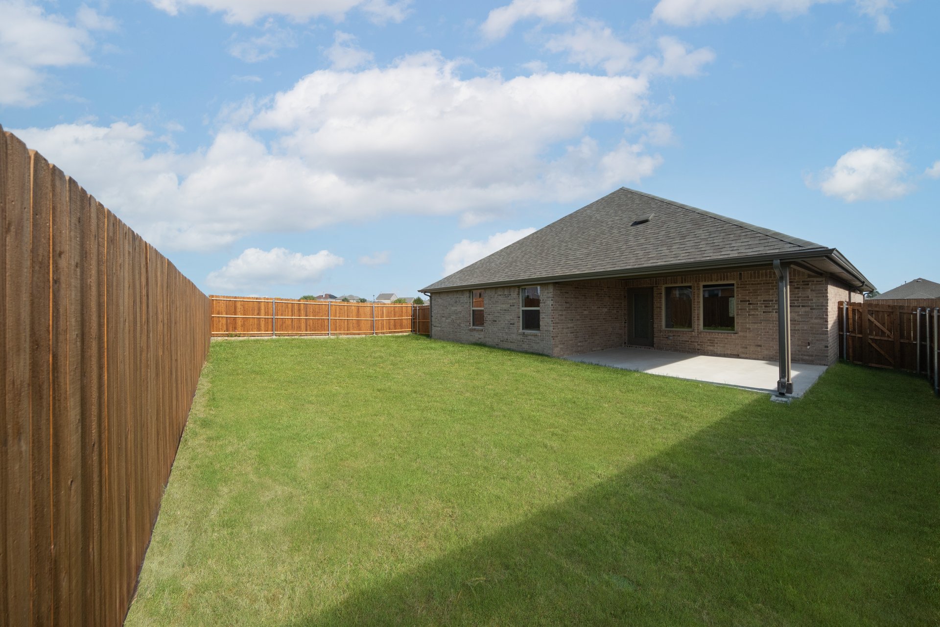backyard with grass and covered patio