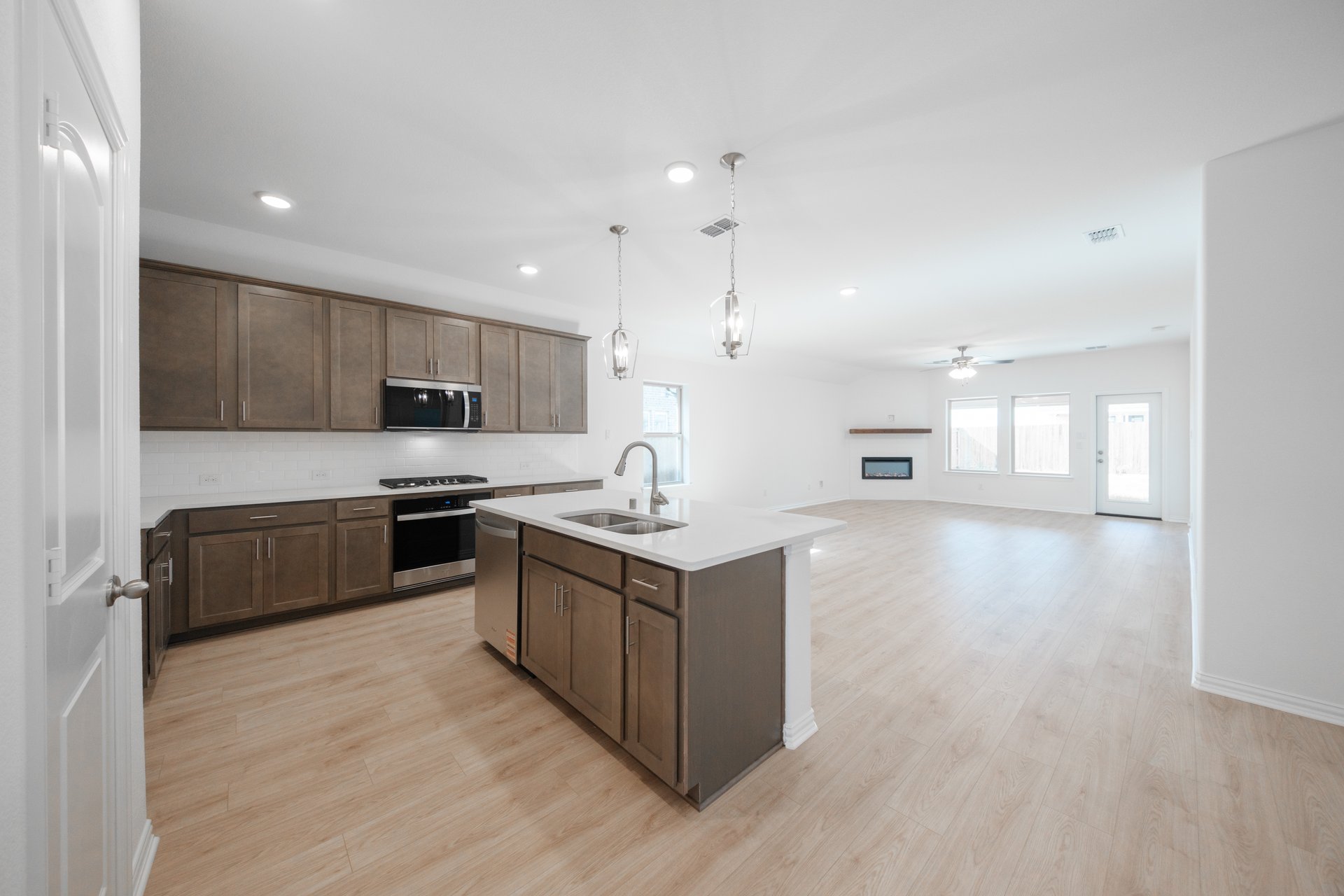 open kitchen with wood floors and island