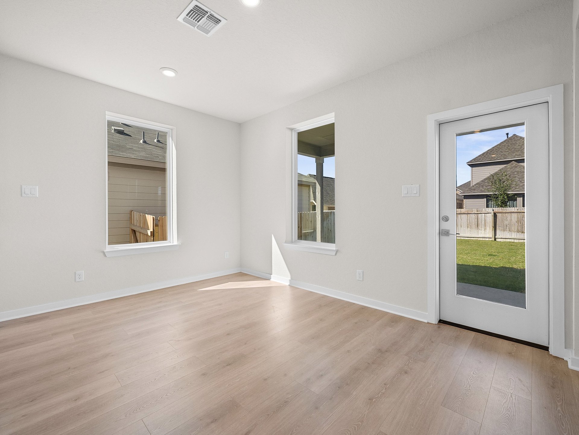 dining area with brown flooring, recessed lighting & windows
