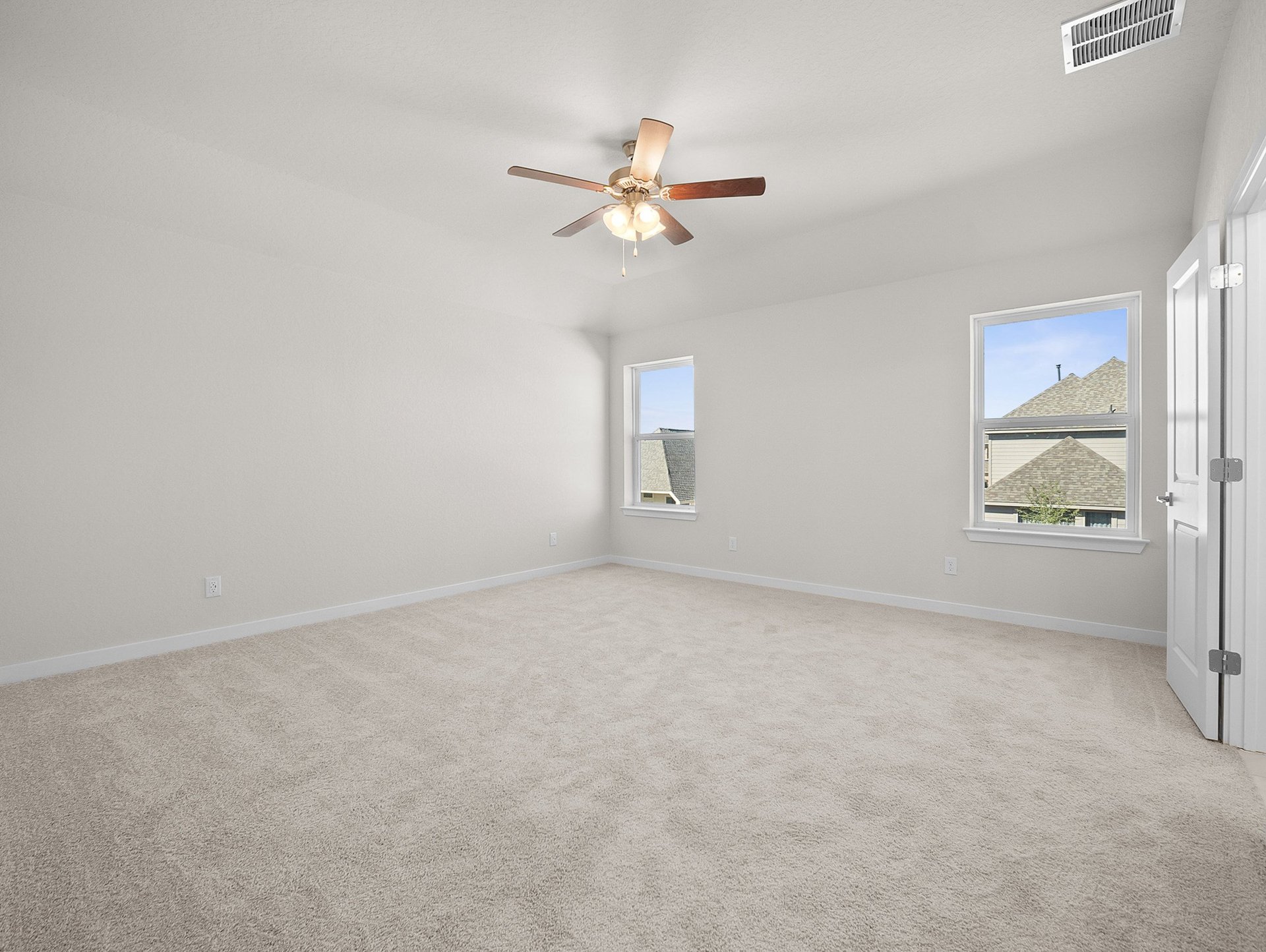 bedroom with carpet, ceiling fan & windows