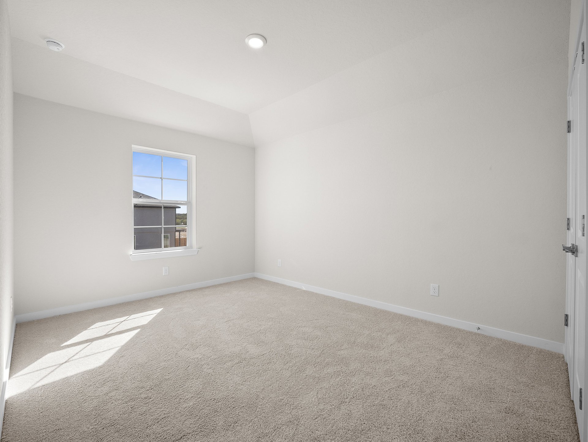 bedroom with carpet, window & a sloped ceiling
