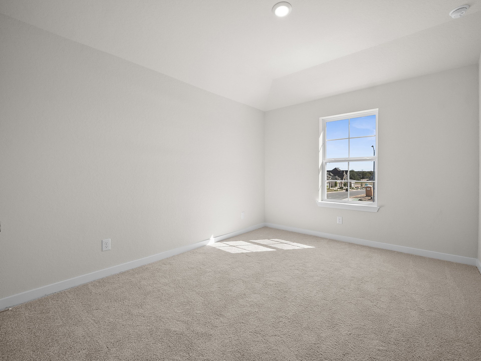 bedroom with carpet, window & a sloped ceiling