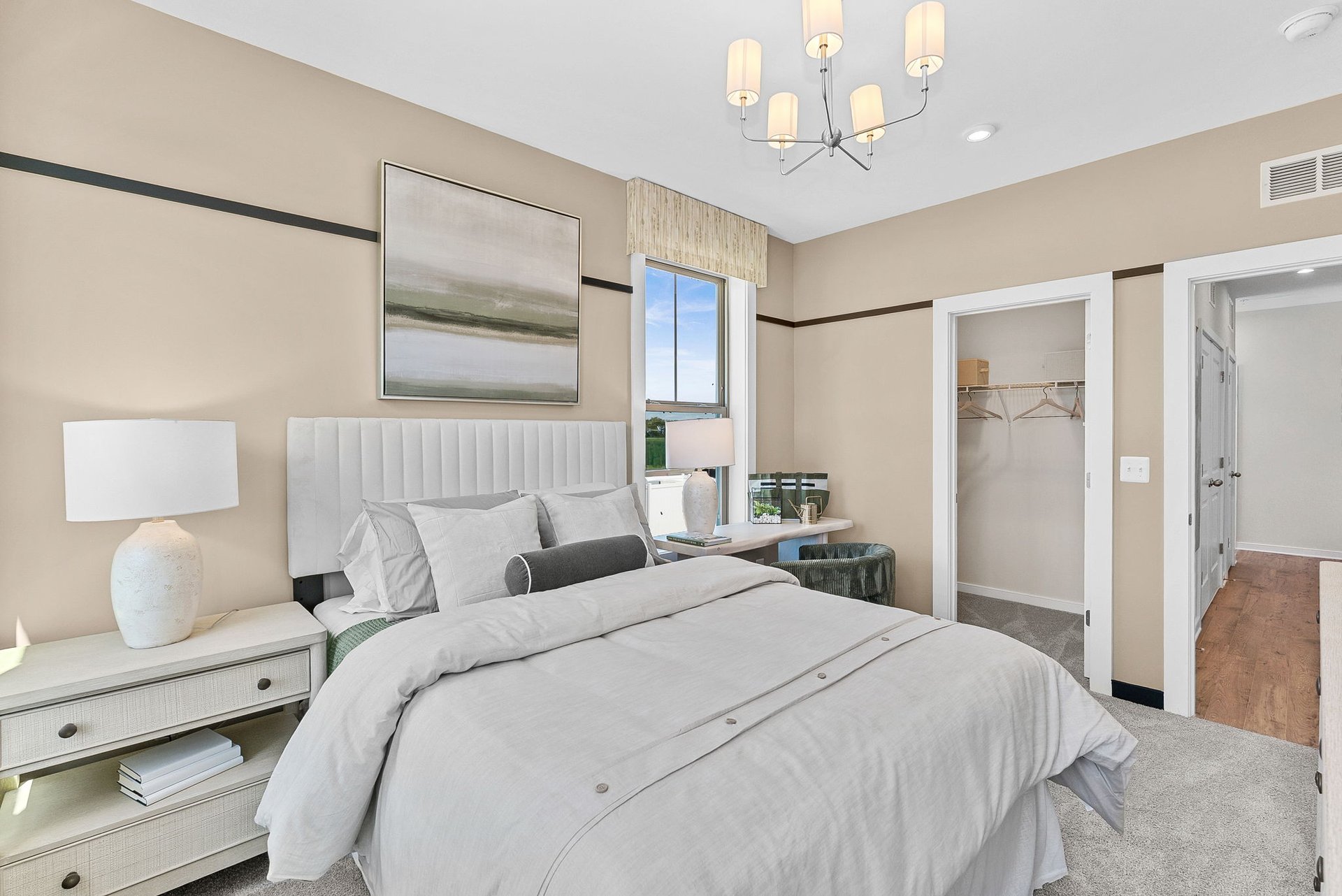 secondary bedroom with a walk-in closet