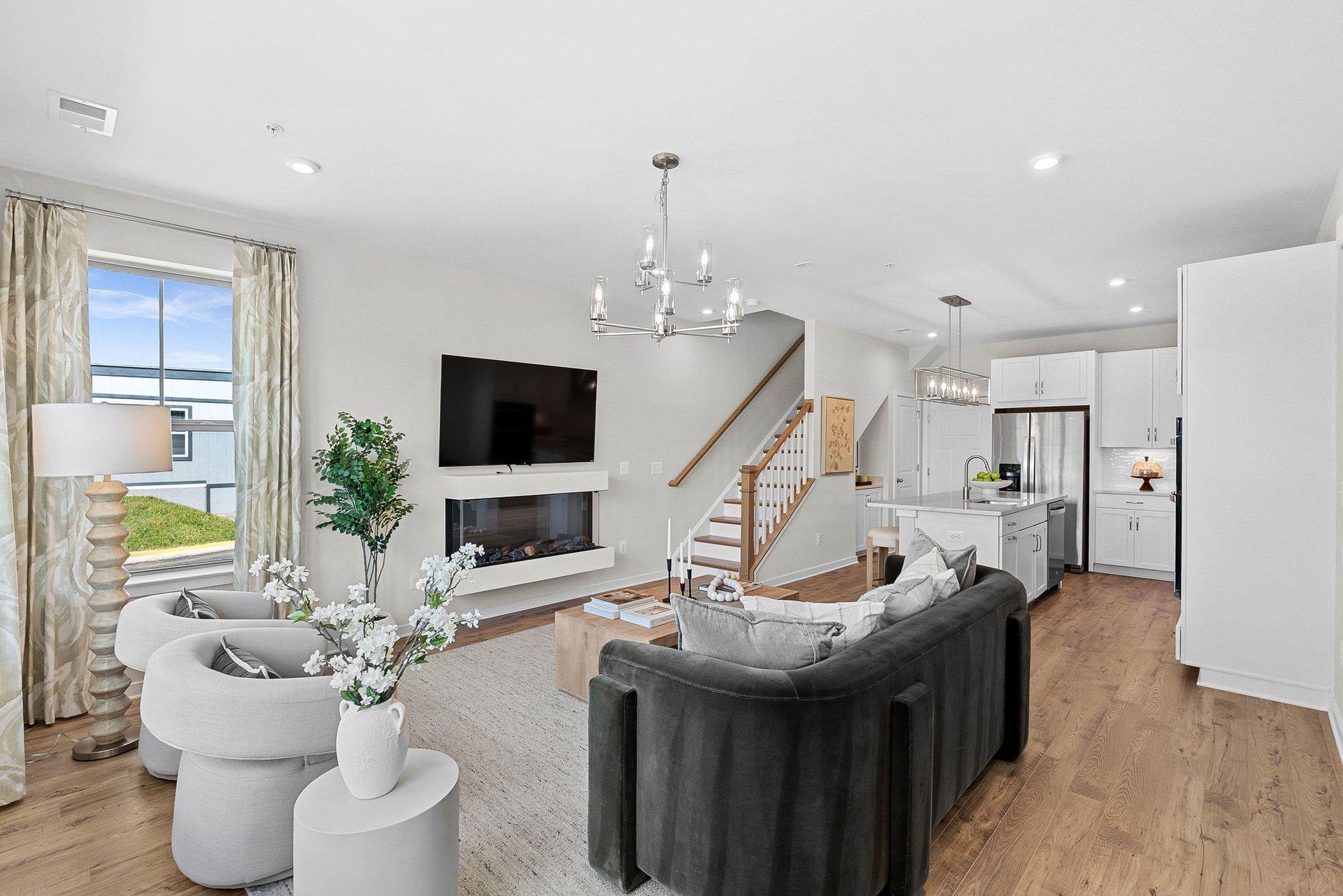 great room with a television and fireplace