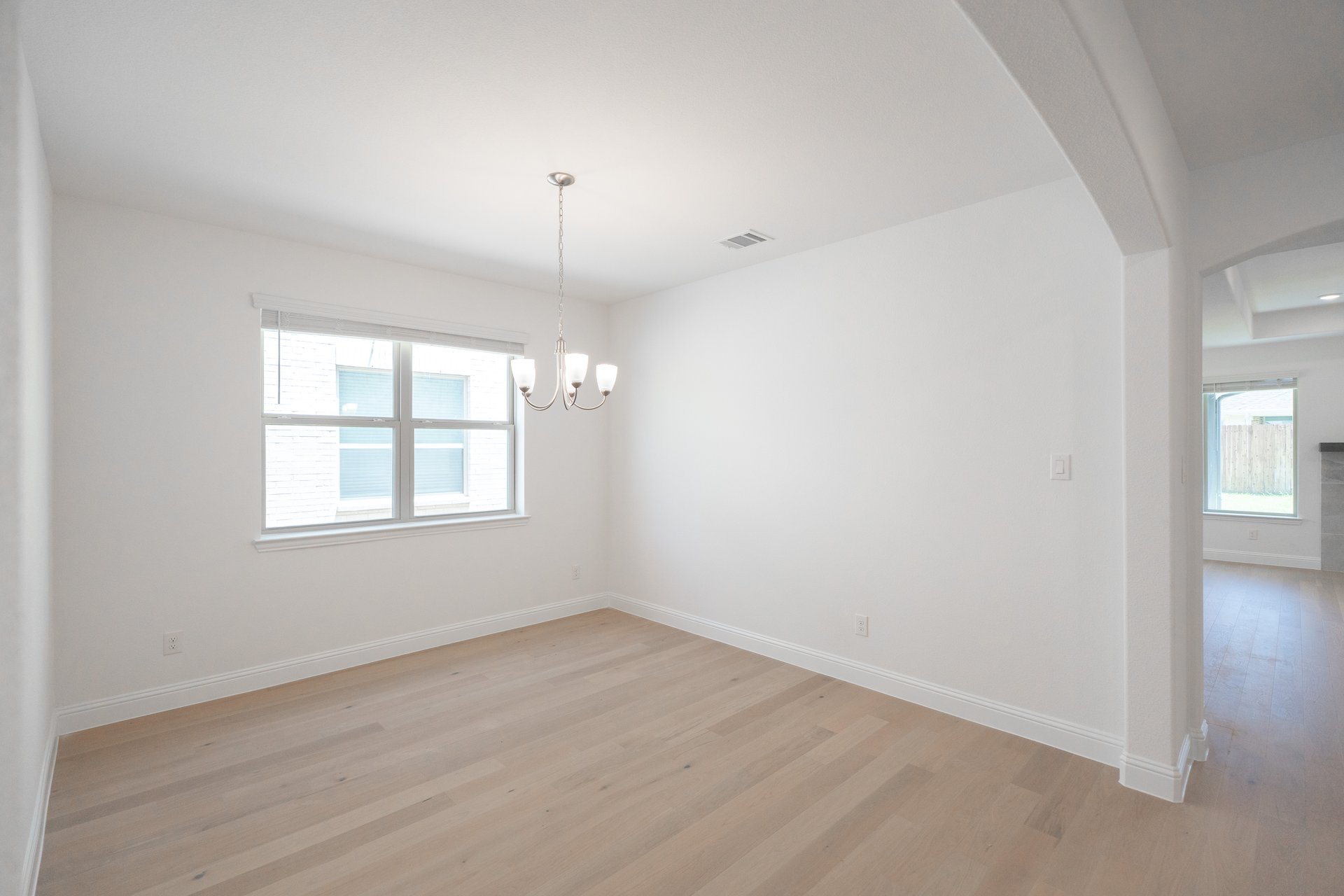 dining room with wood flooring and chandelier 