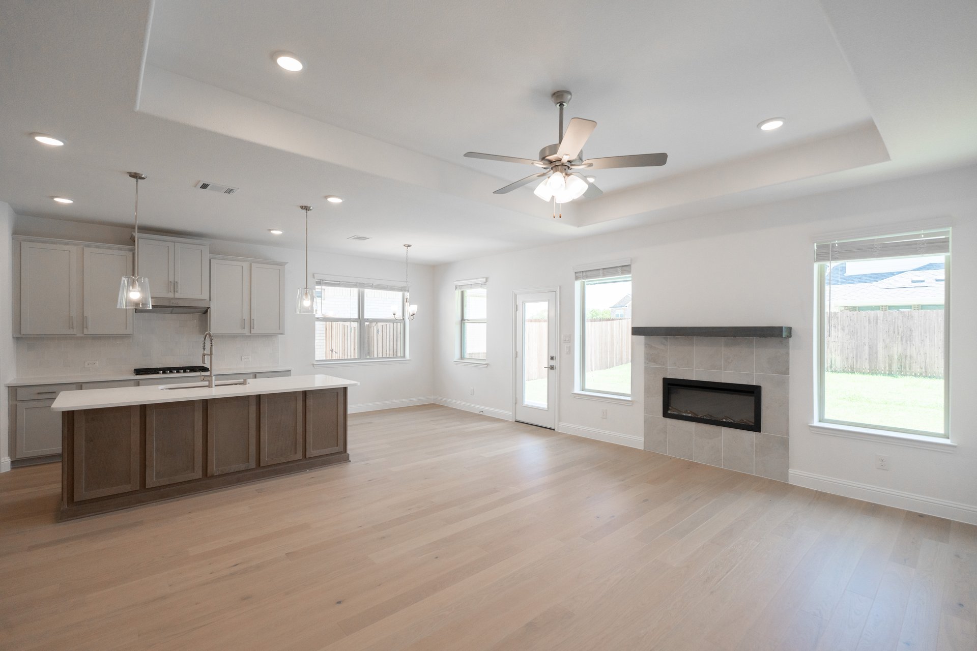 great room with fireplace and wood flooring 