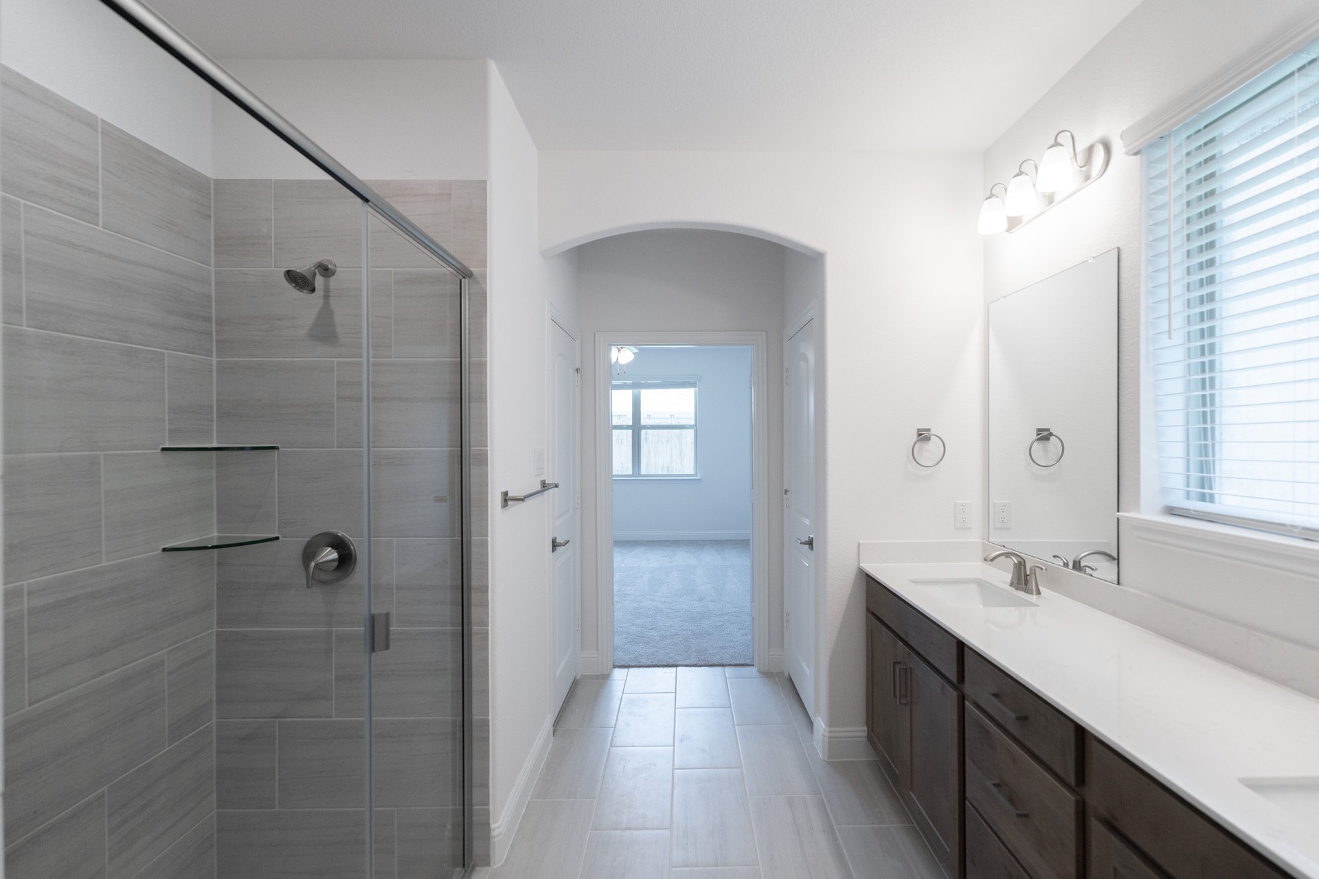 bathroom with walk-in shower and white countertops 
