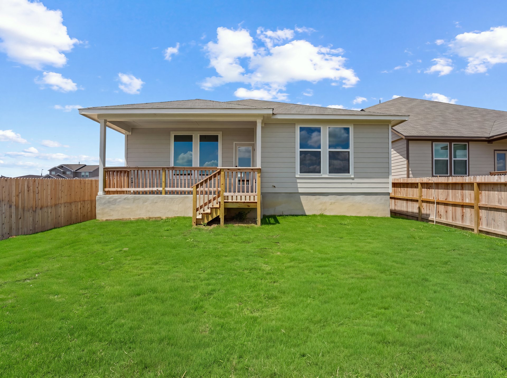backyard with green landscaped grass