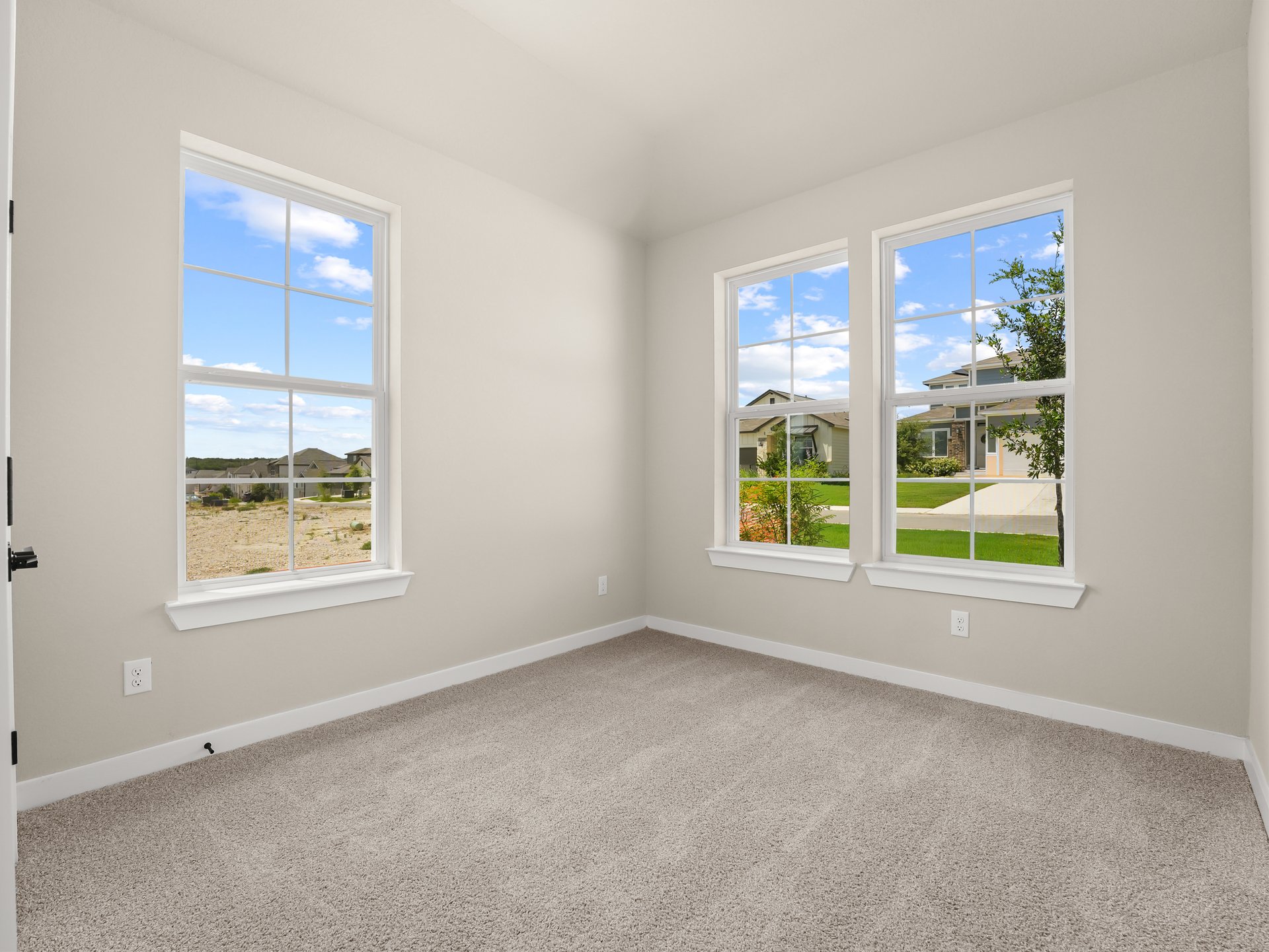 secondary bedroom with dual windows and carpet 