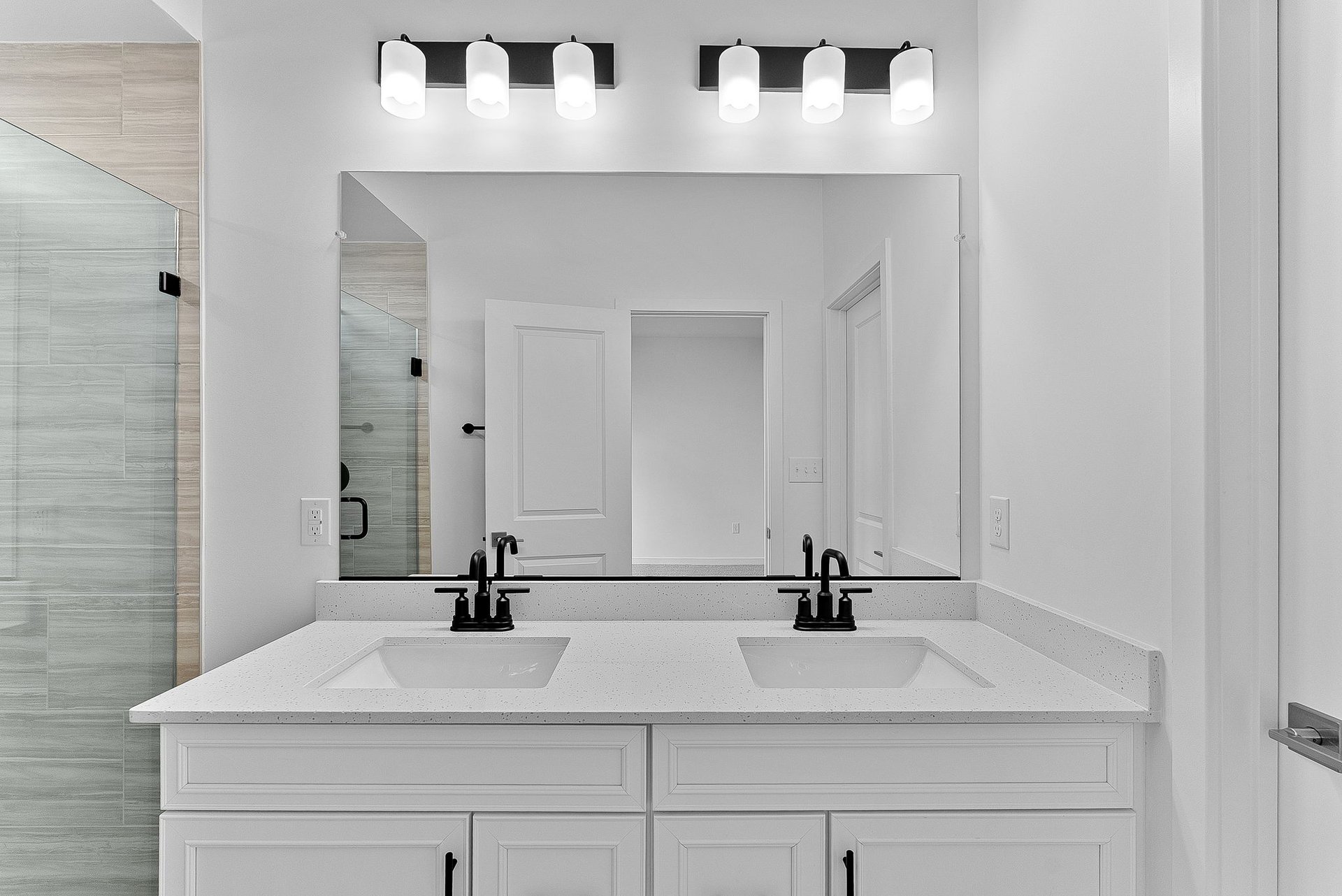 primary bathroom with two sinks and a large mirror