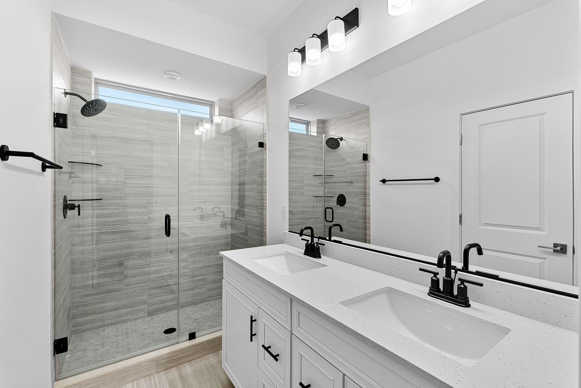 primary bathroom with an oversized shower and two sinks