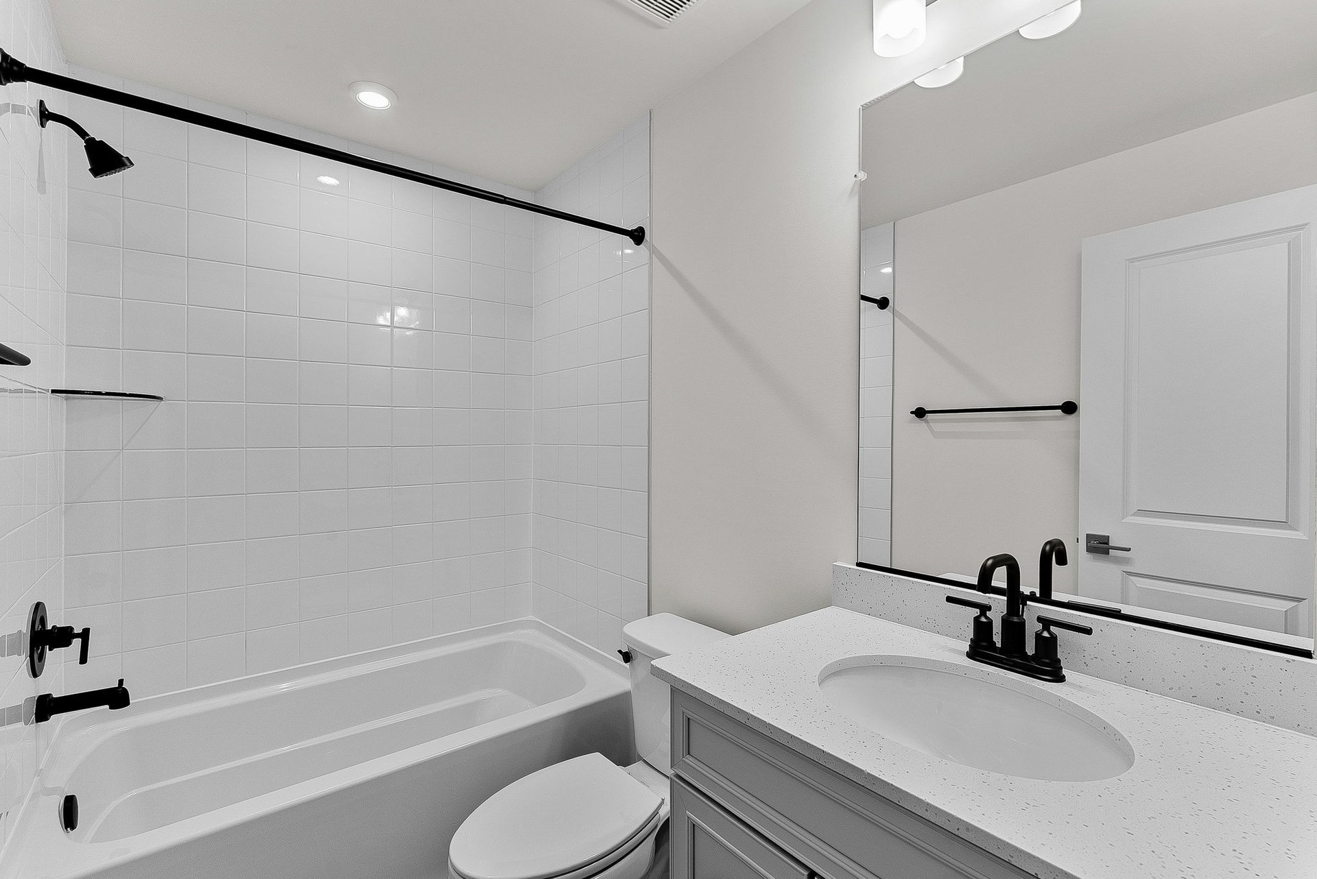 secondary bathroom with a tub and shower combo