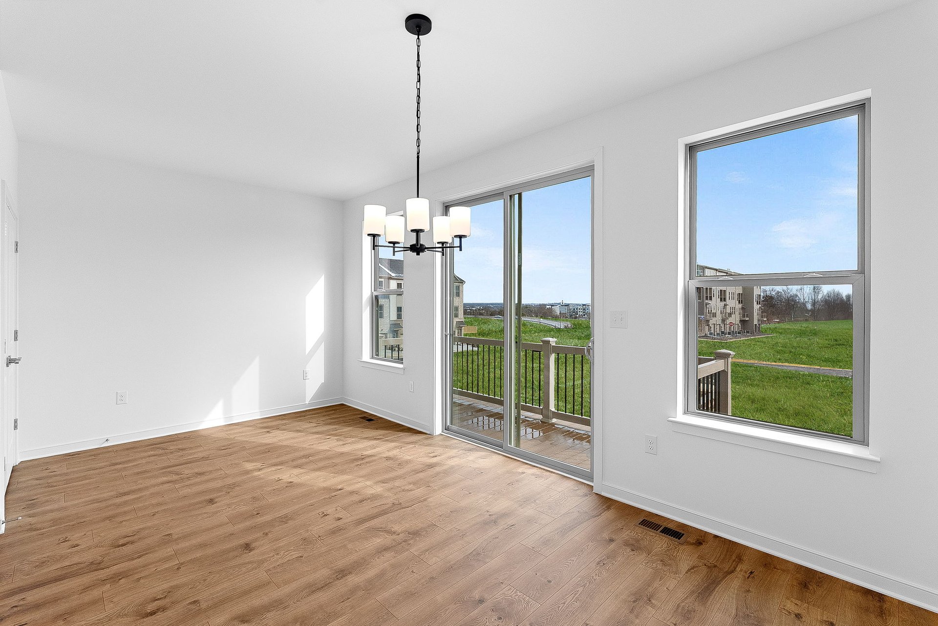 dining area with access to the deck and a view of the community