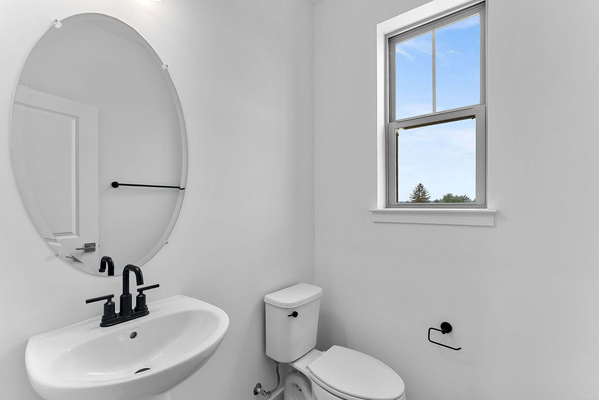 powder room with a pedestal sink and a window