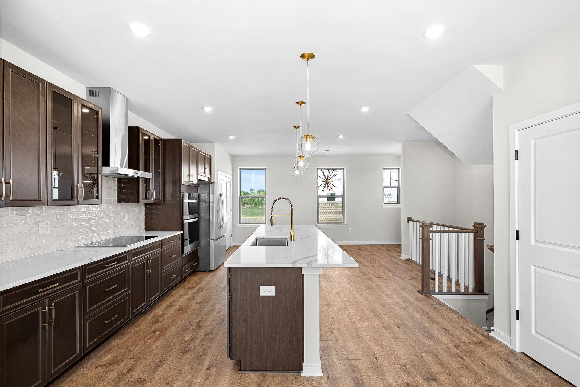 kitchen with an island with a sink and pendant lighting
