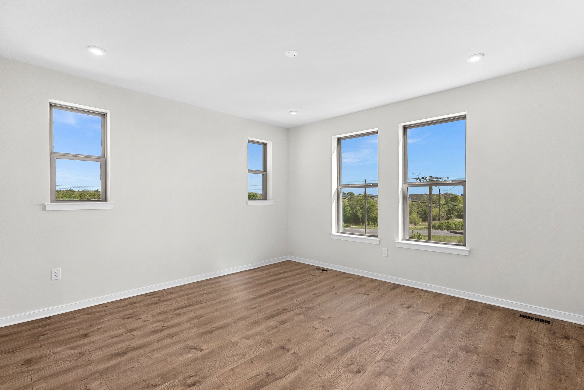 primary bedroom with several windows