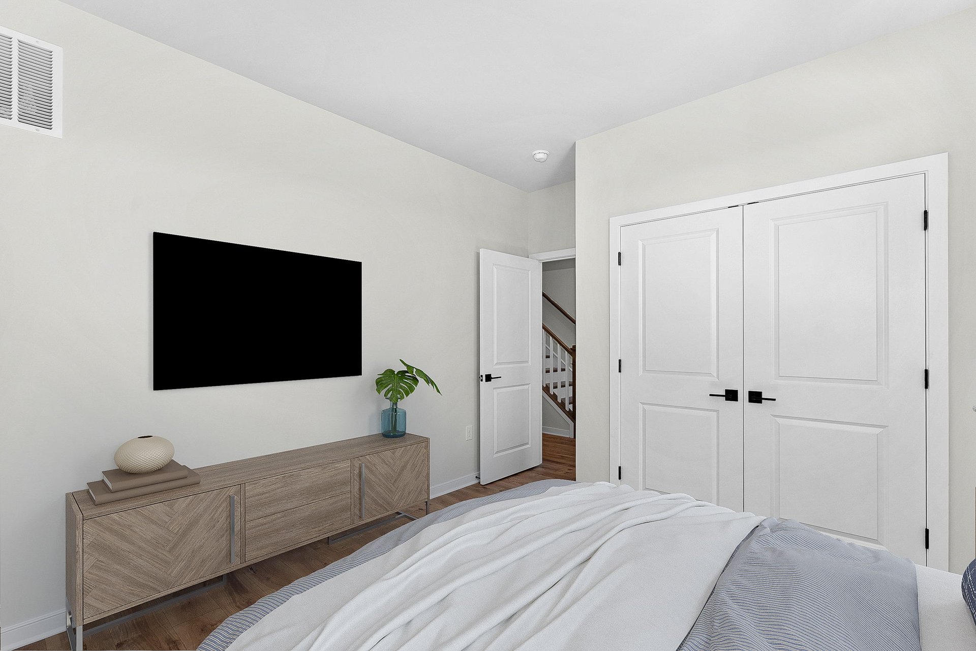 lower-level secondary bedroom with a mounted television