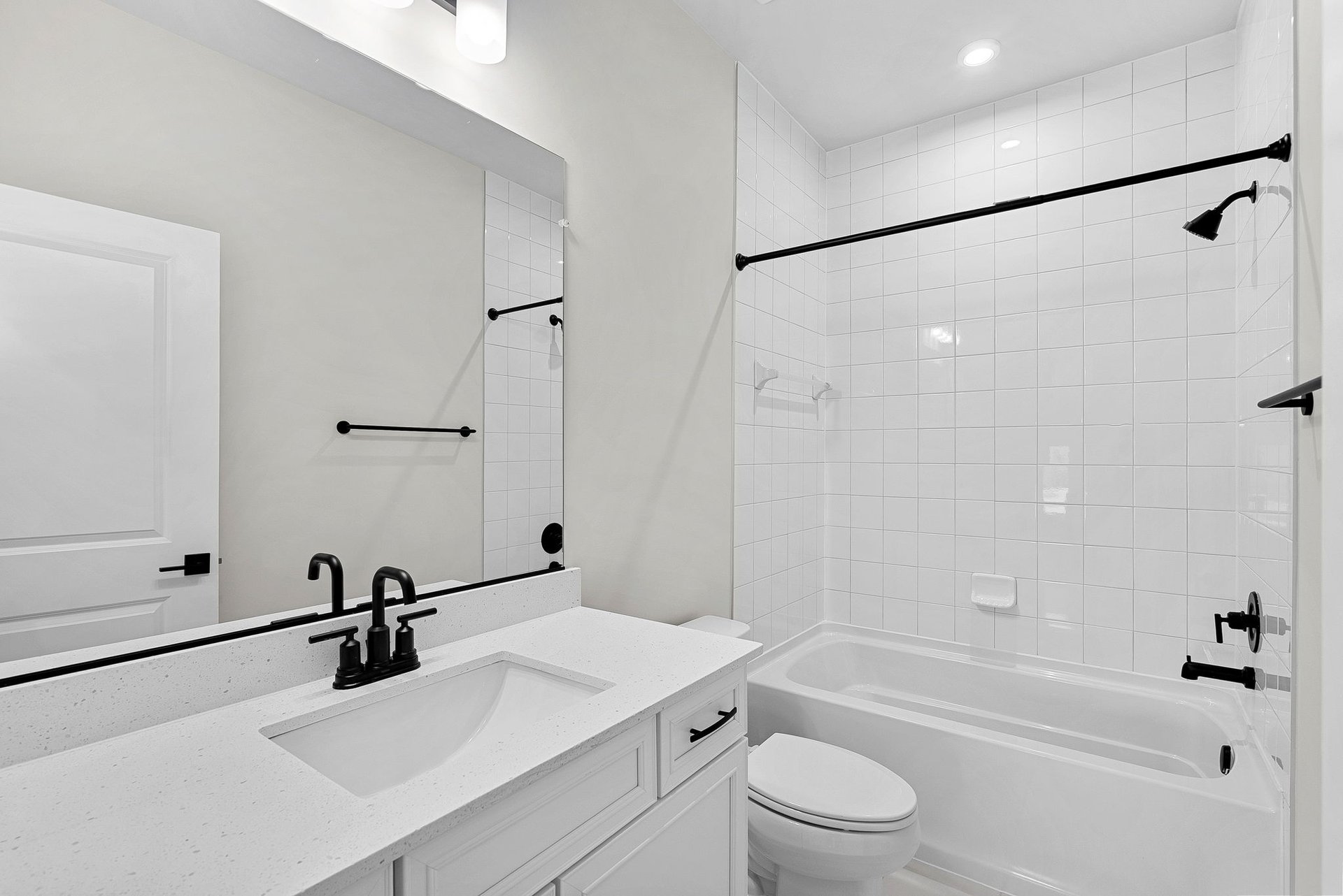 secondary bathroom with a shower and tub combination