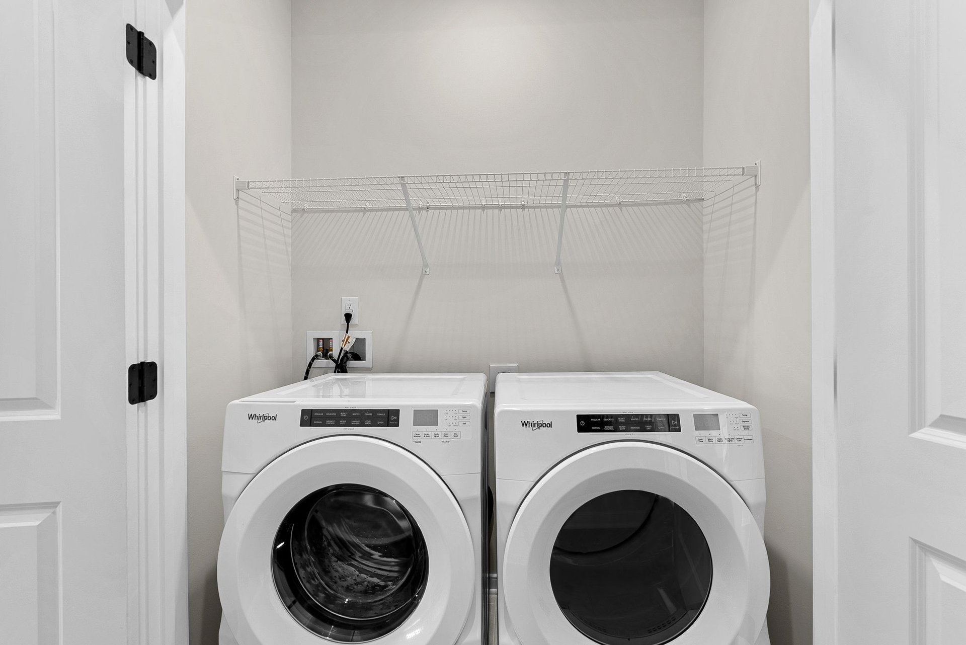 laundry with a washer, dryer and a shelf