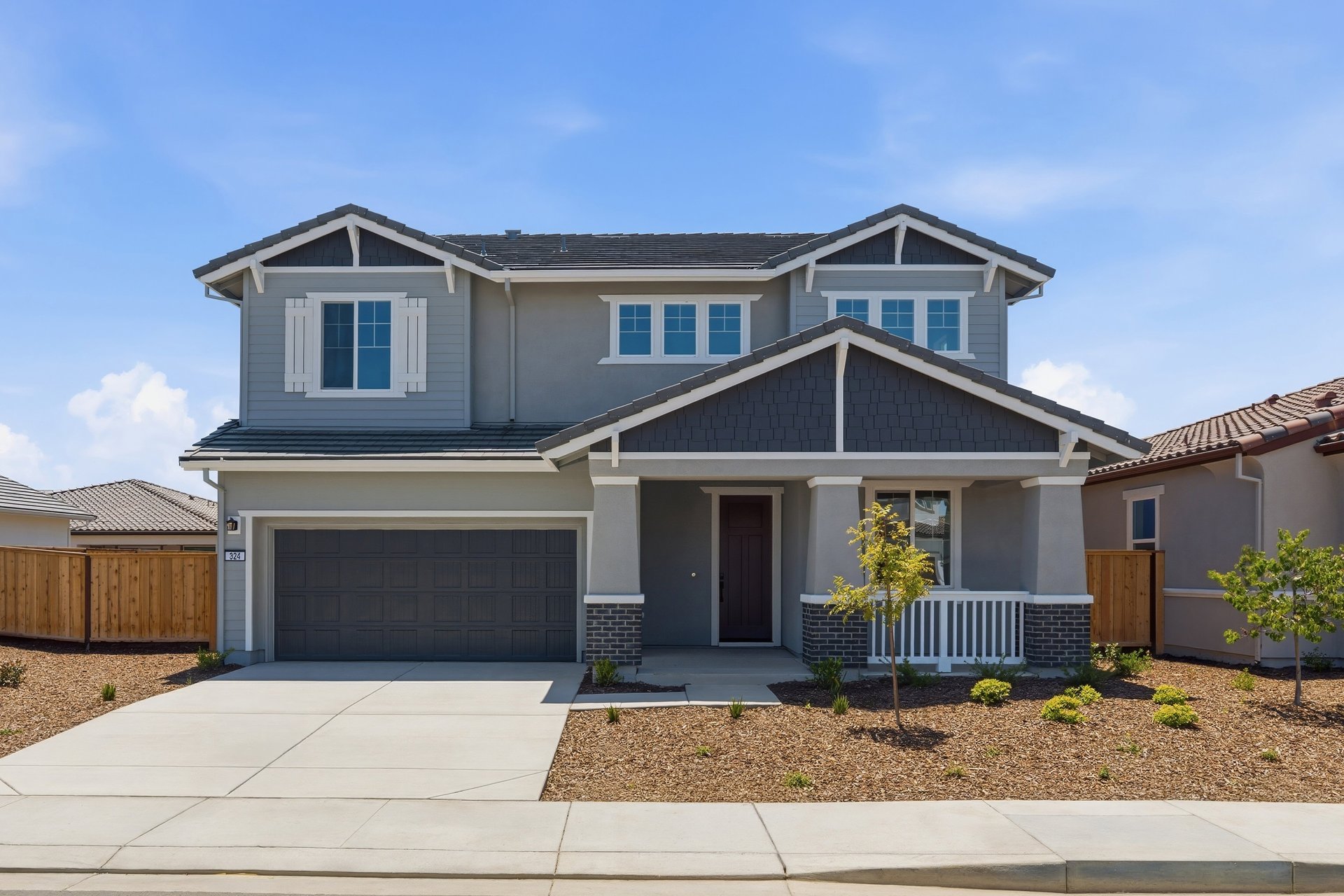 front exterior of two-story gray and white home with covered front porch