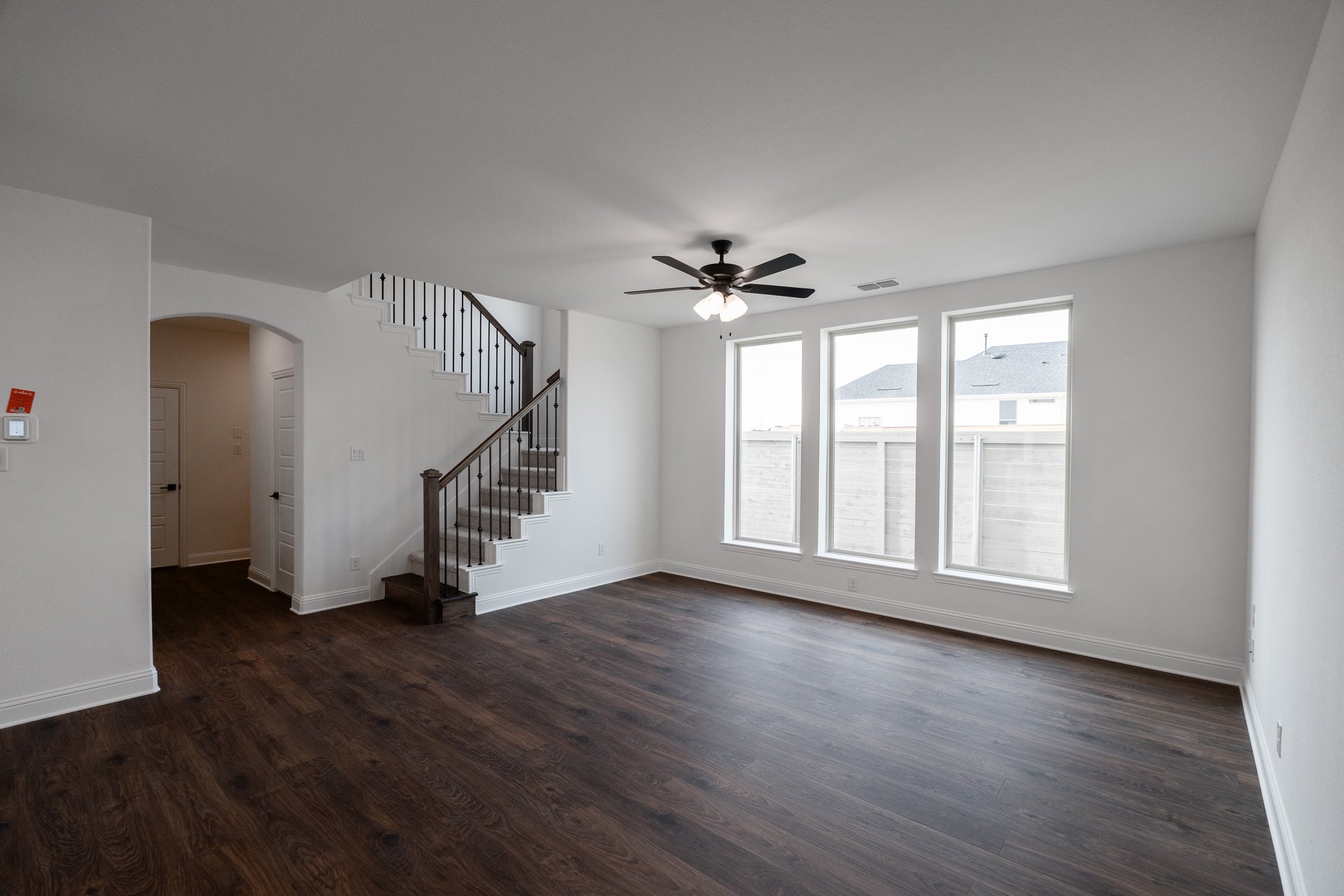 open great room with wood floors and windows