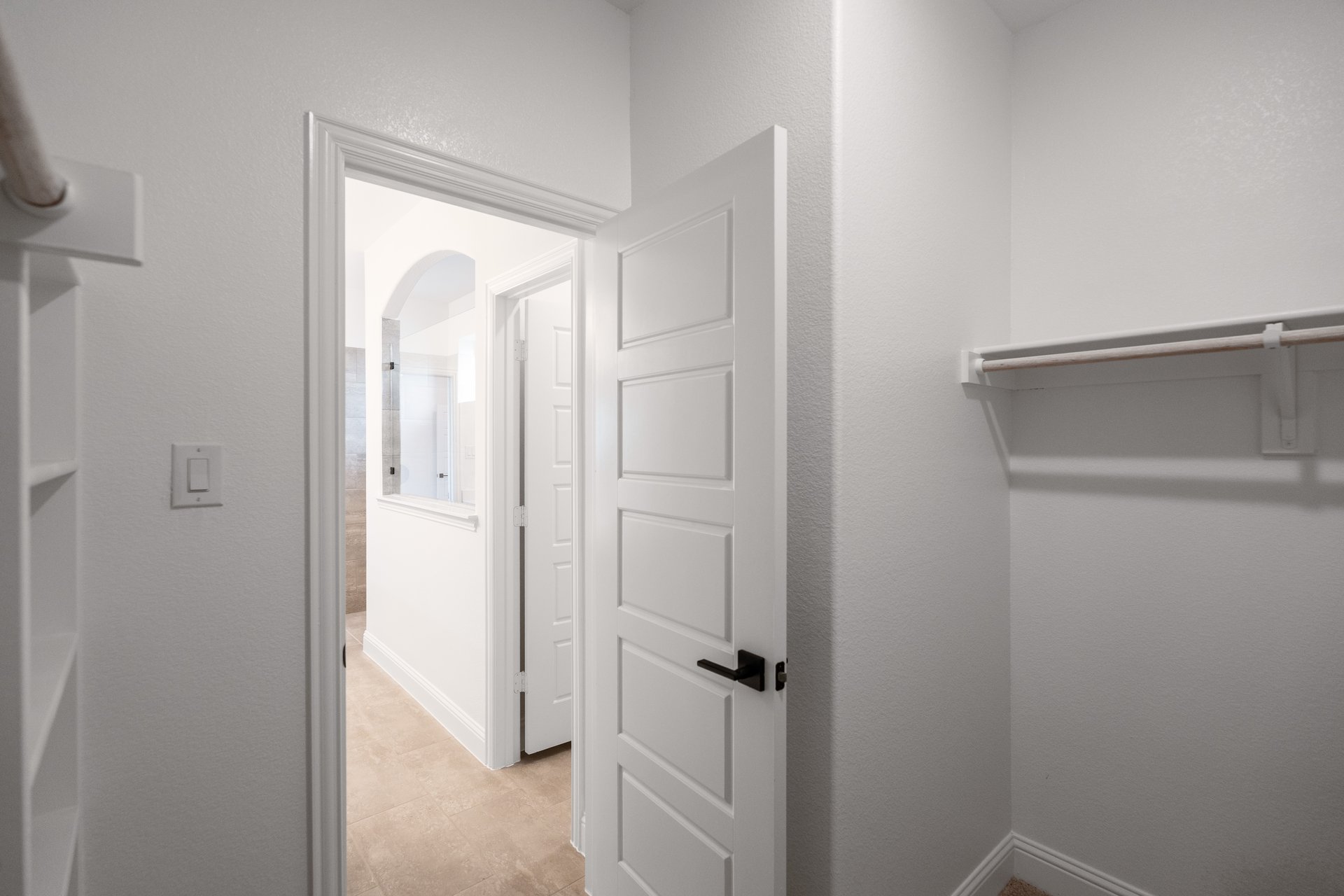 primary bedroom closet with carpet and white shelves
