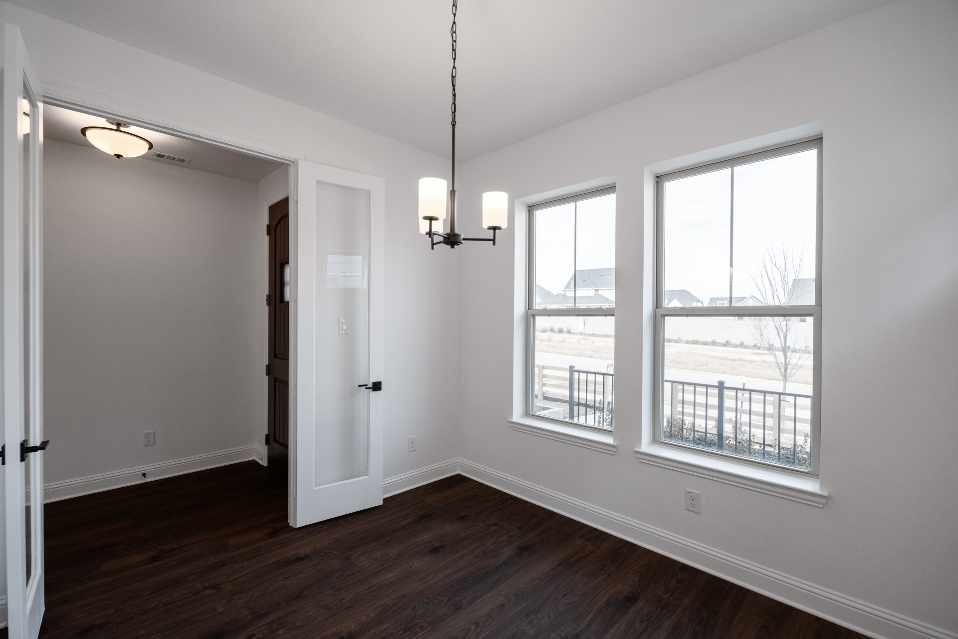 private study with wood floors and french doors