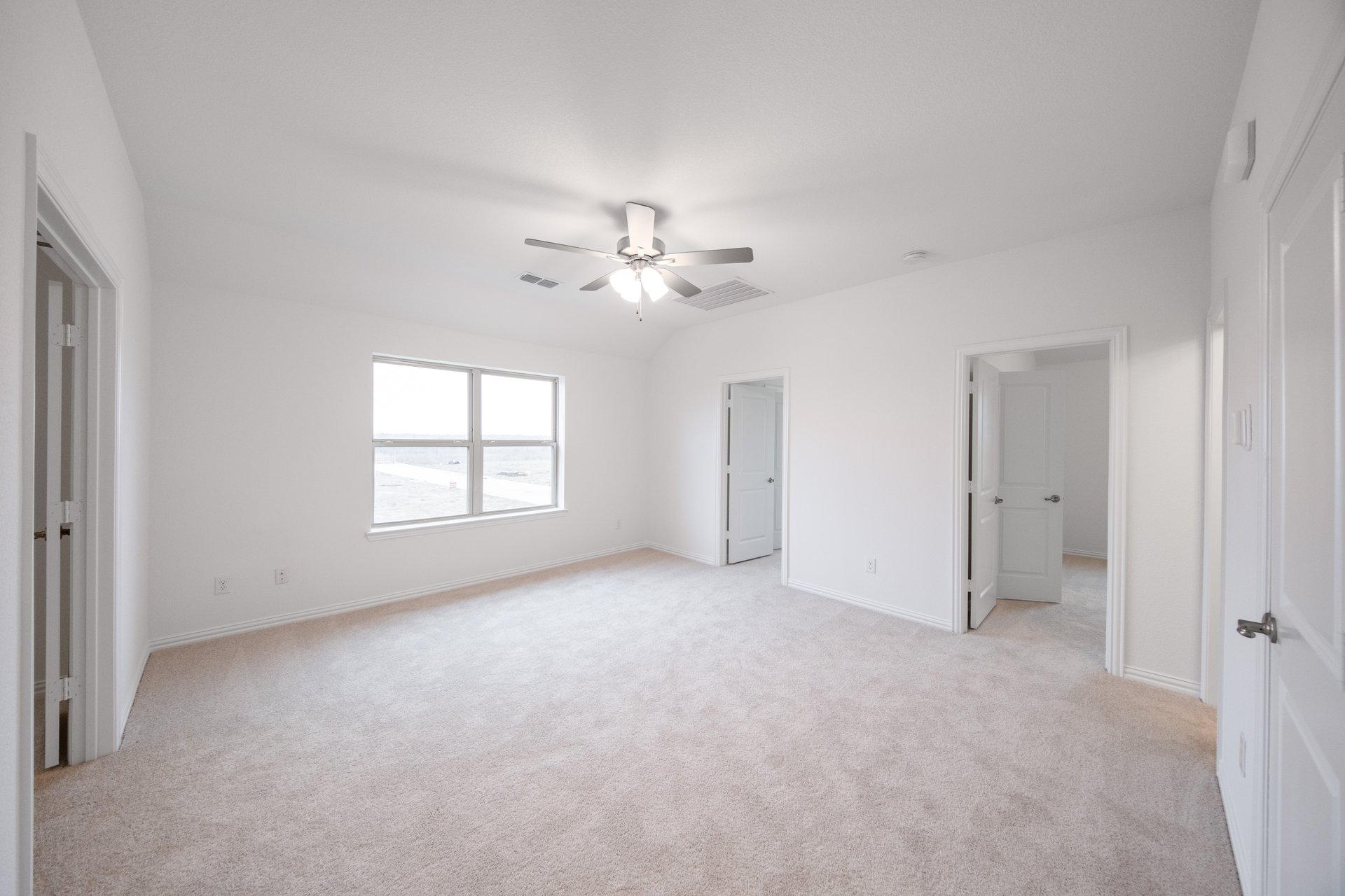 loft with carpet, window, and ceiling fan
