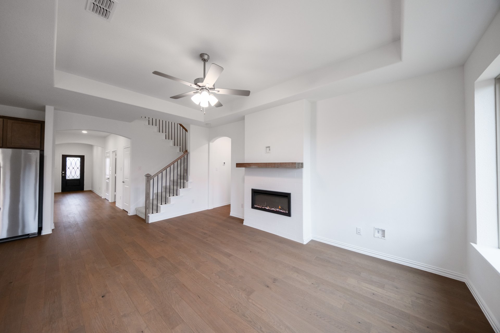 open great room with wood floors and fireplace