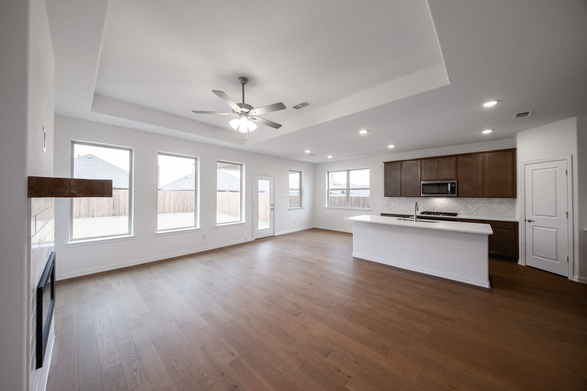 open great room and kitchen with wood floors
