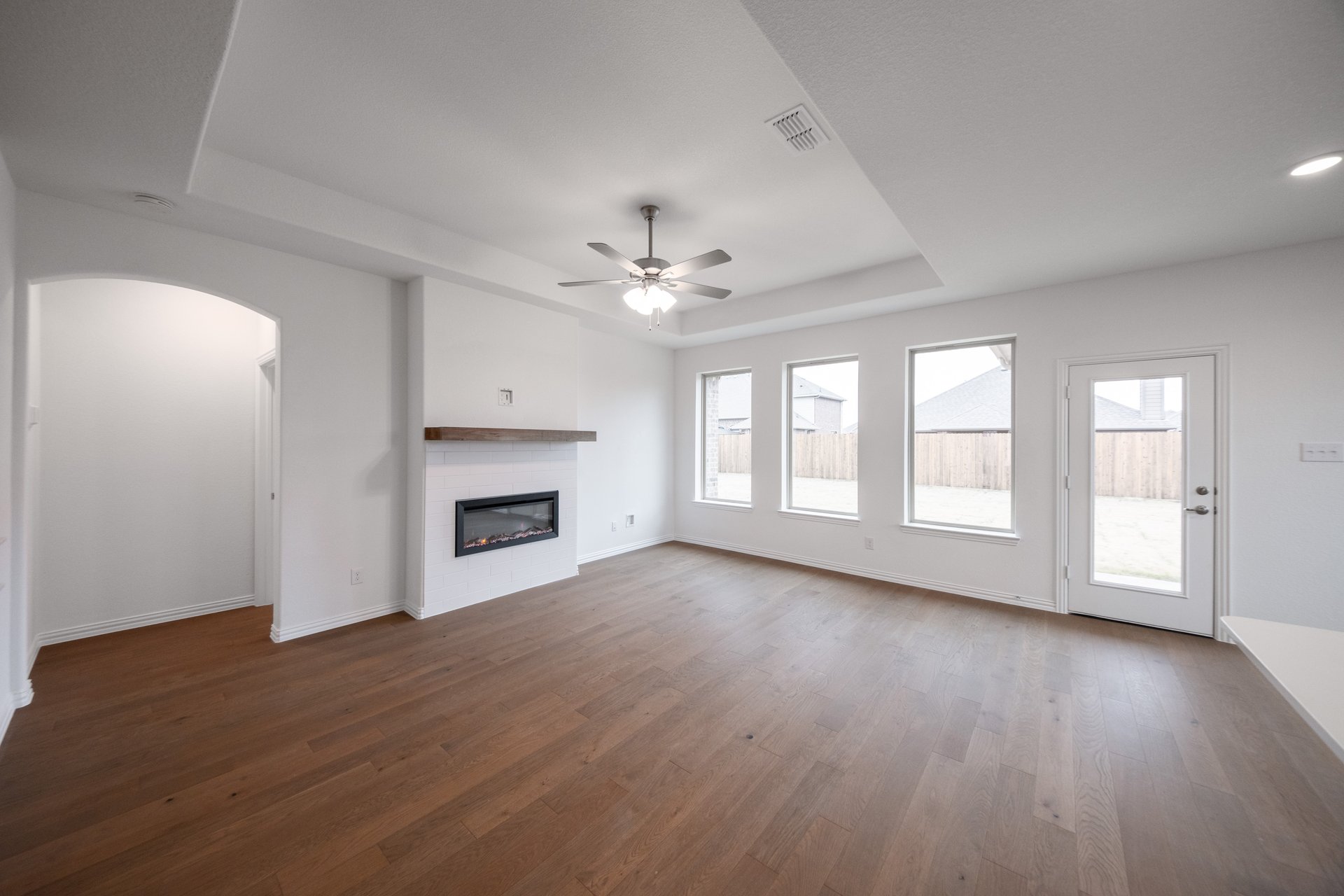 open great room with wood floors and fireplace