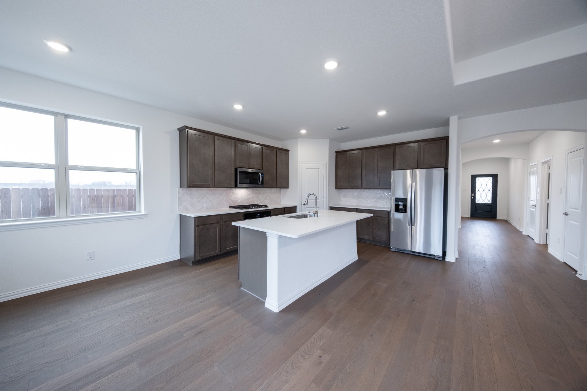 open kitchen with wood floors and island