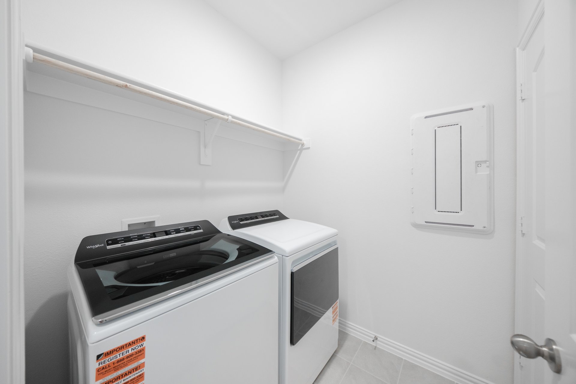 laundry room with tile floors, washer, and dryer