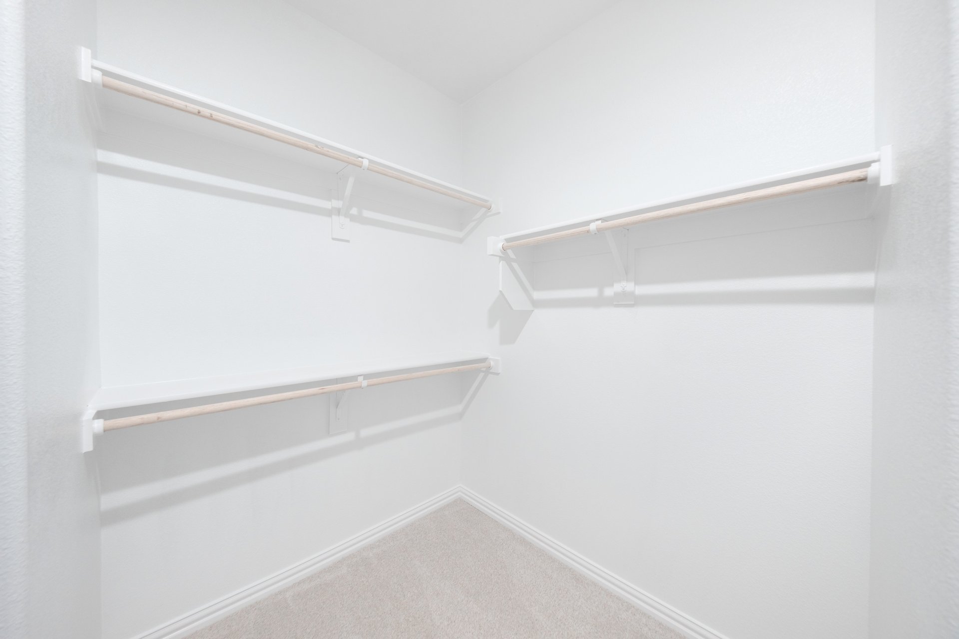 primary bedroom closet with carpet and white shelves