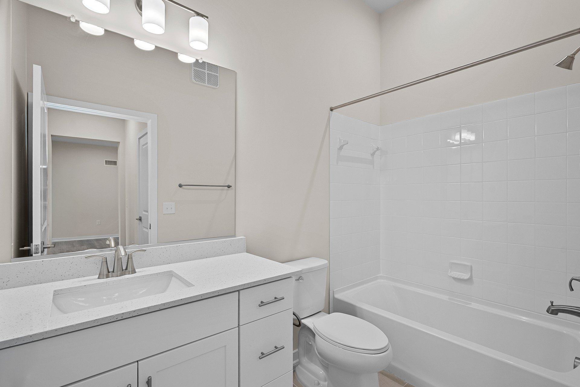 secondary bathroom with sink, tub, shower and mirror