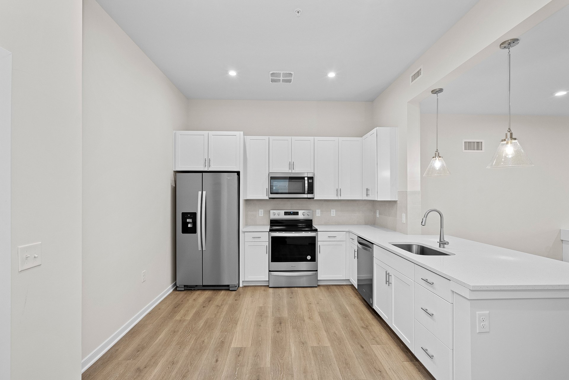 kitchen with quartz countertops and white cabinets