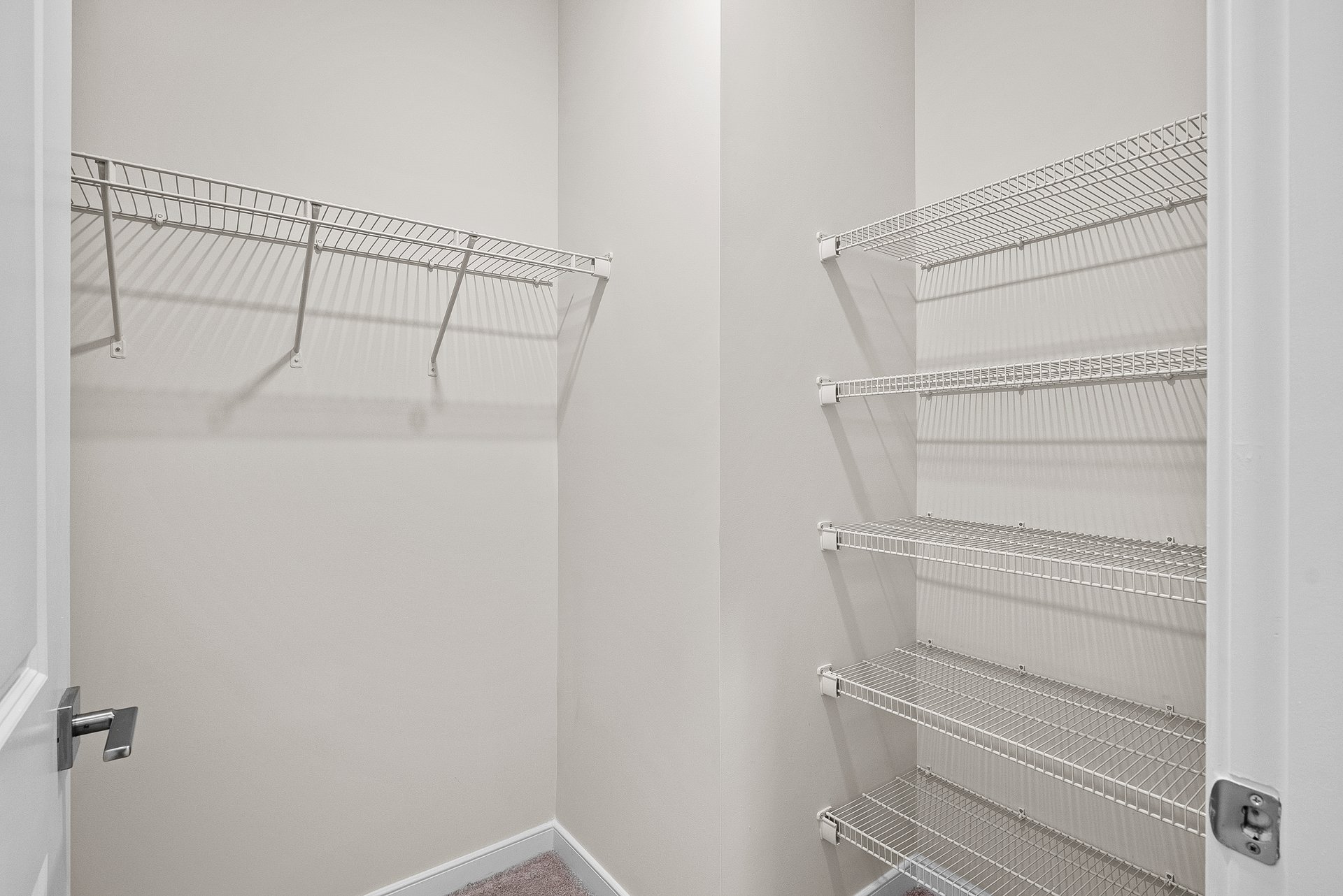 primary bedroom walk in closet with racks