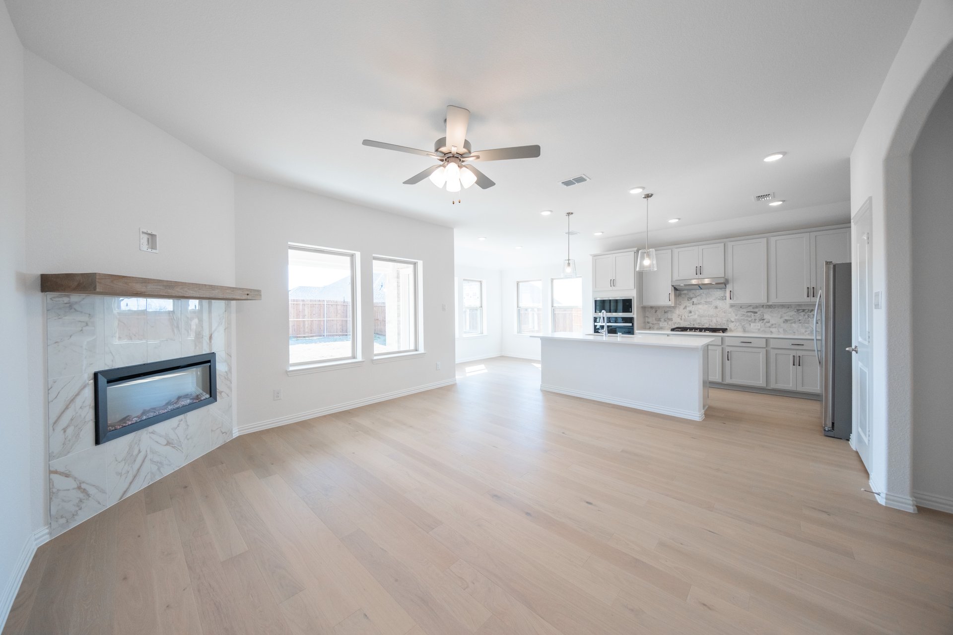great room with open concept and wood flooring