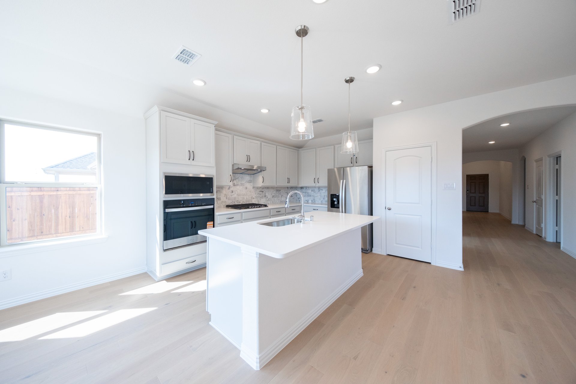 open concept kitchen with white cabinets