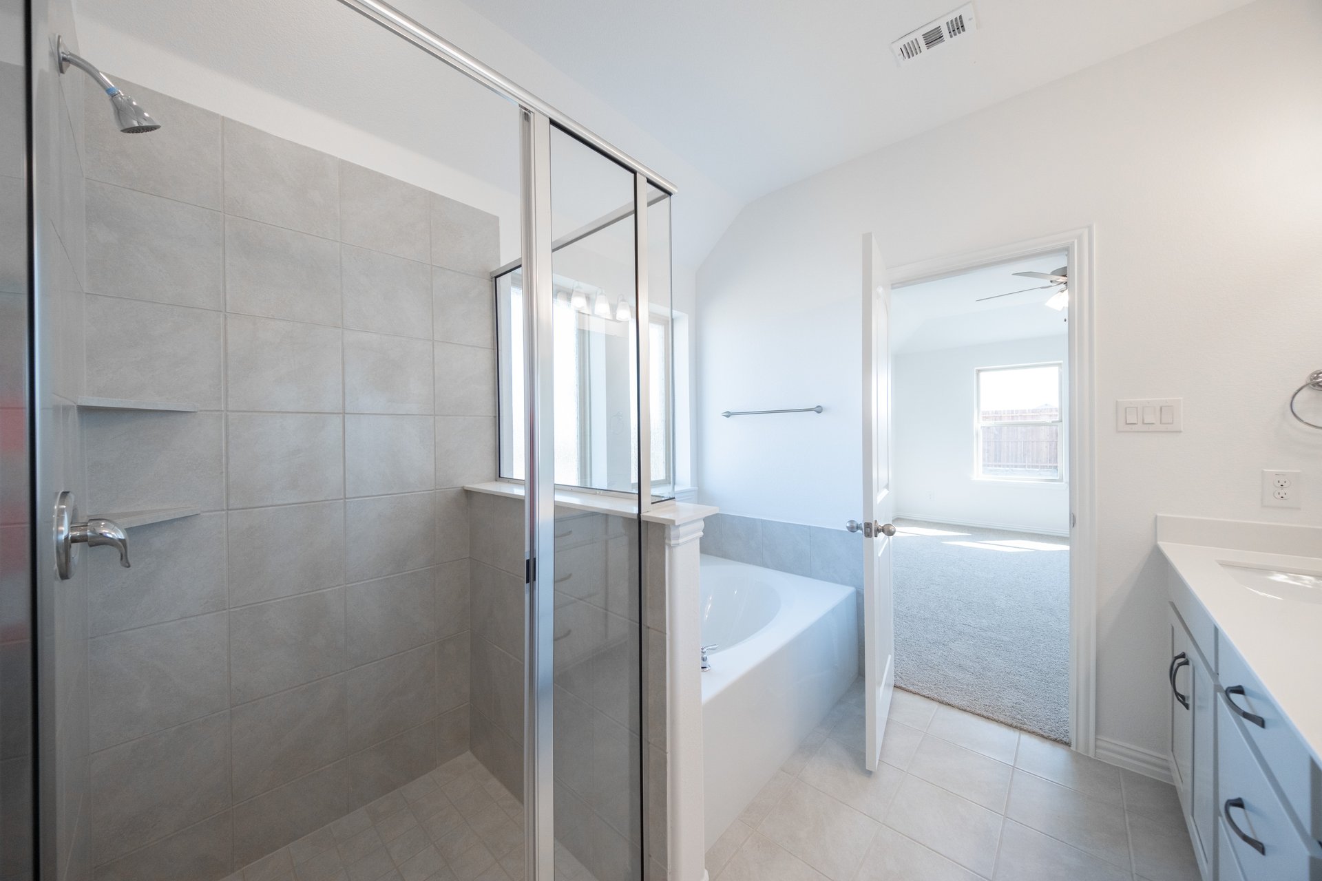 primary bathroom with shower and tub