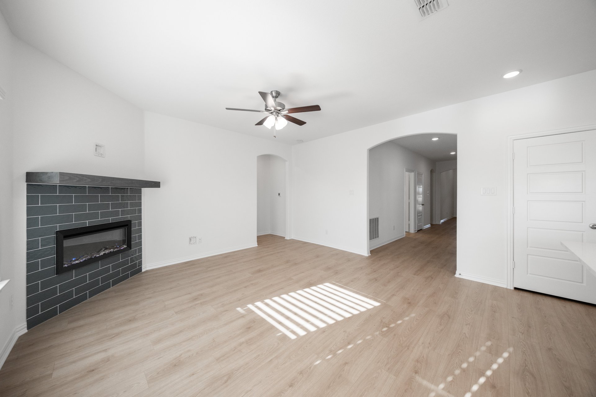 open great room with wood floors and fireplace