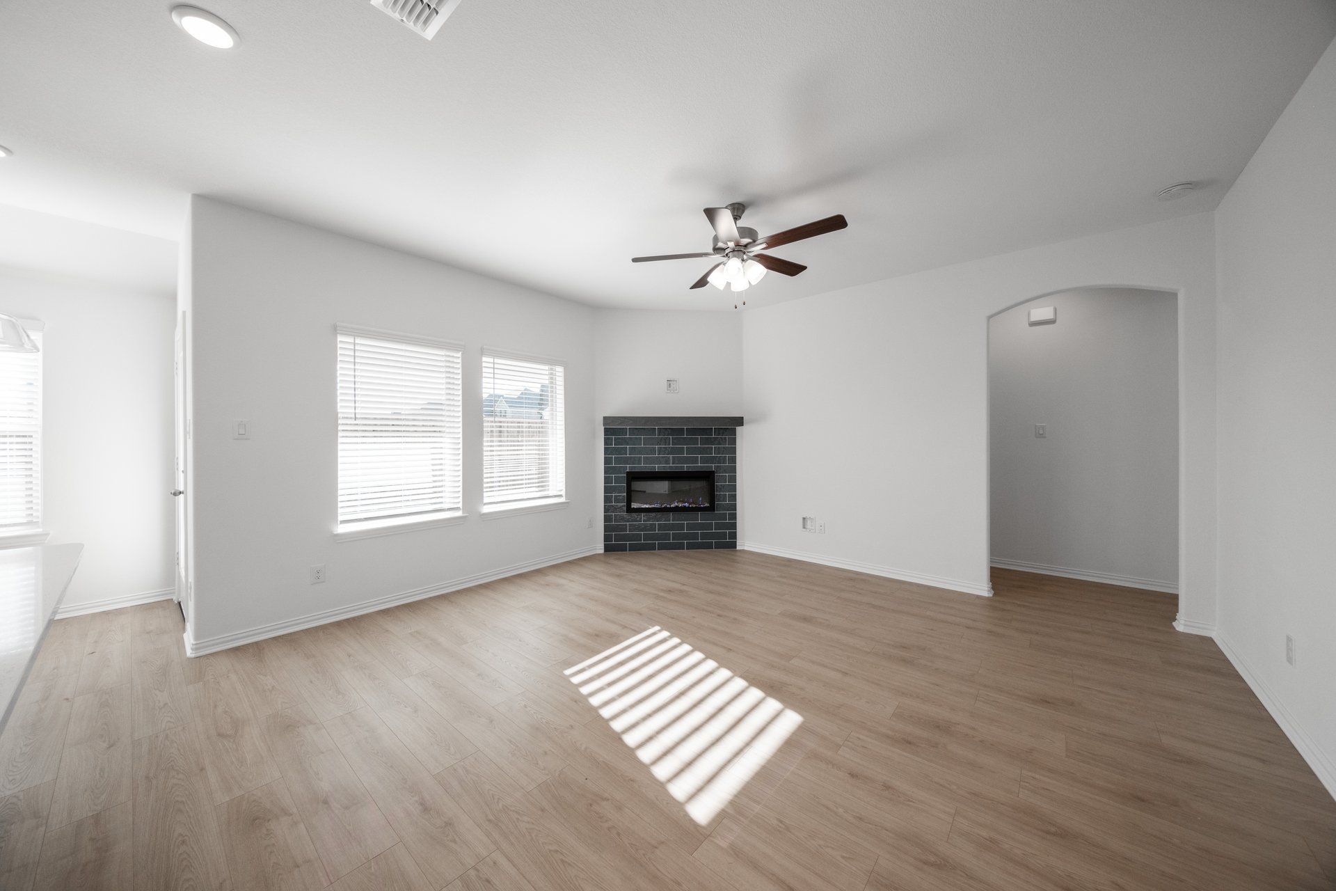 open great room with wood floors and fireplace