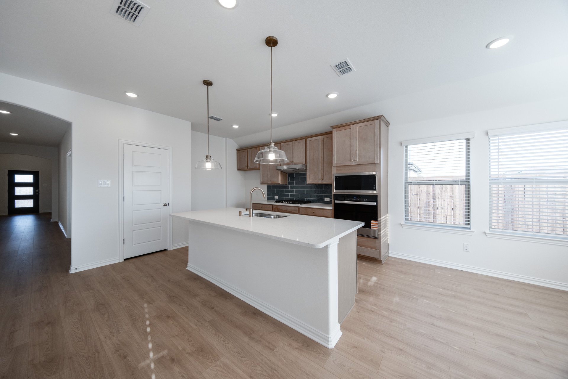 open kitchen with wood floors and large island