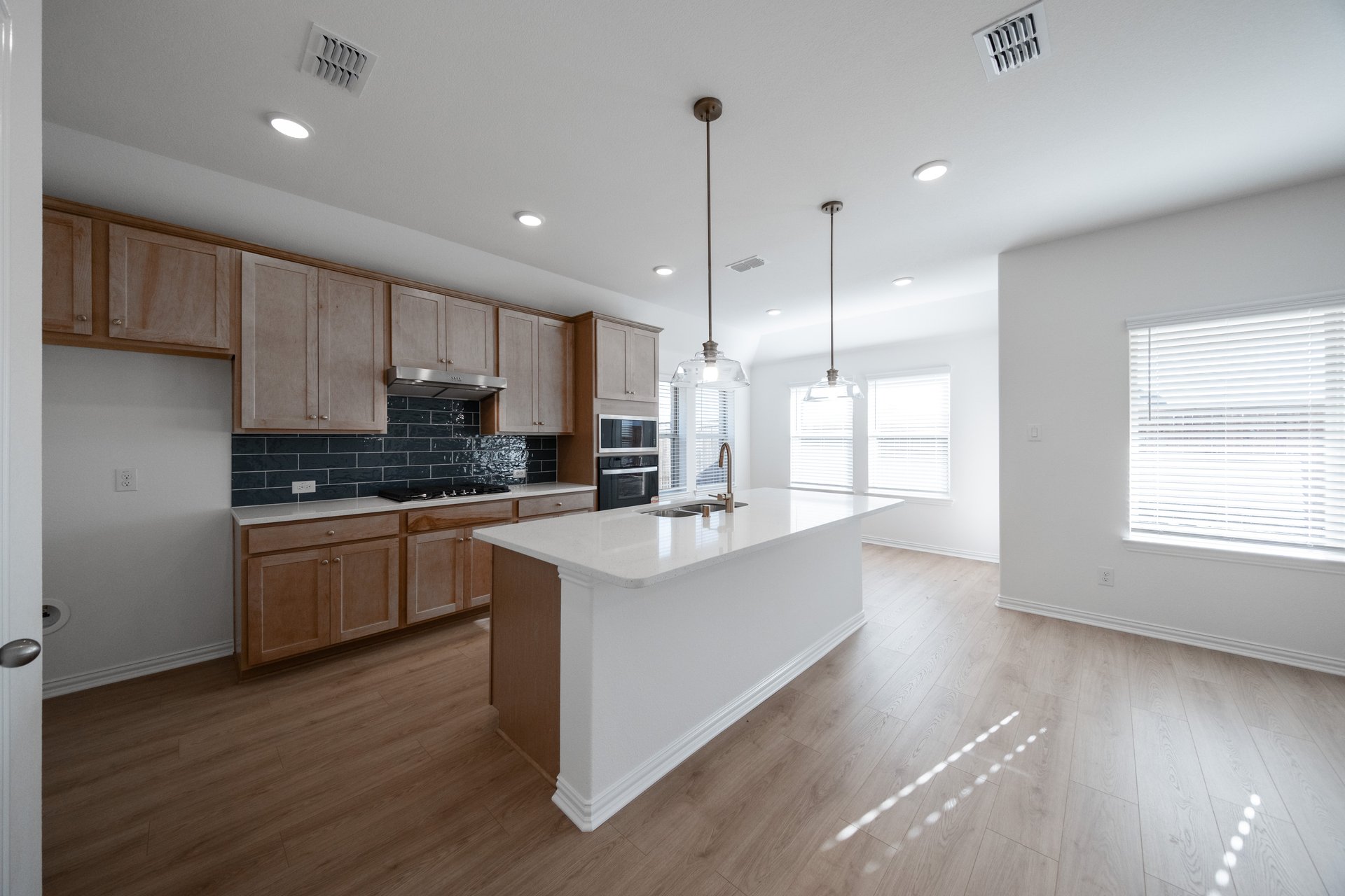 open kitchen with wood floors and island
