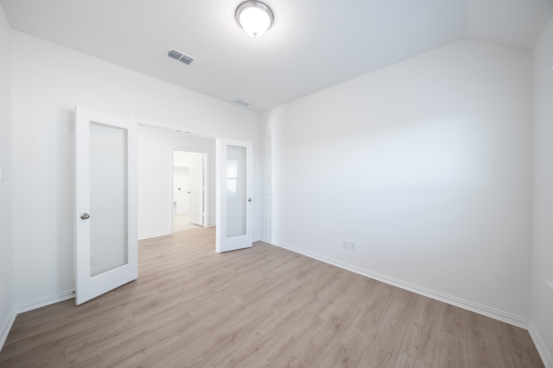 private study with wood floors and french doors