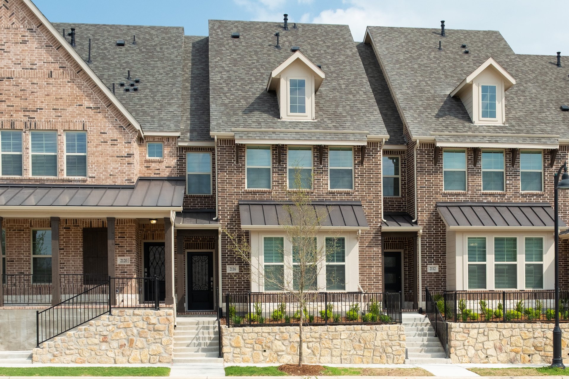 townhouse exterior with brick and landscaping