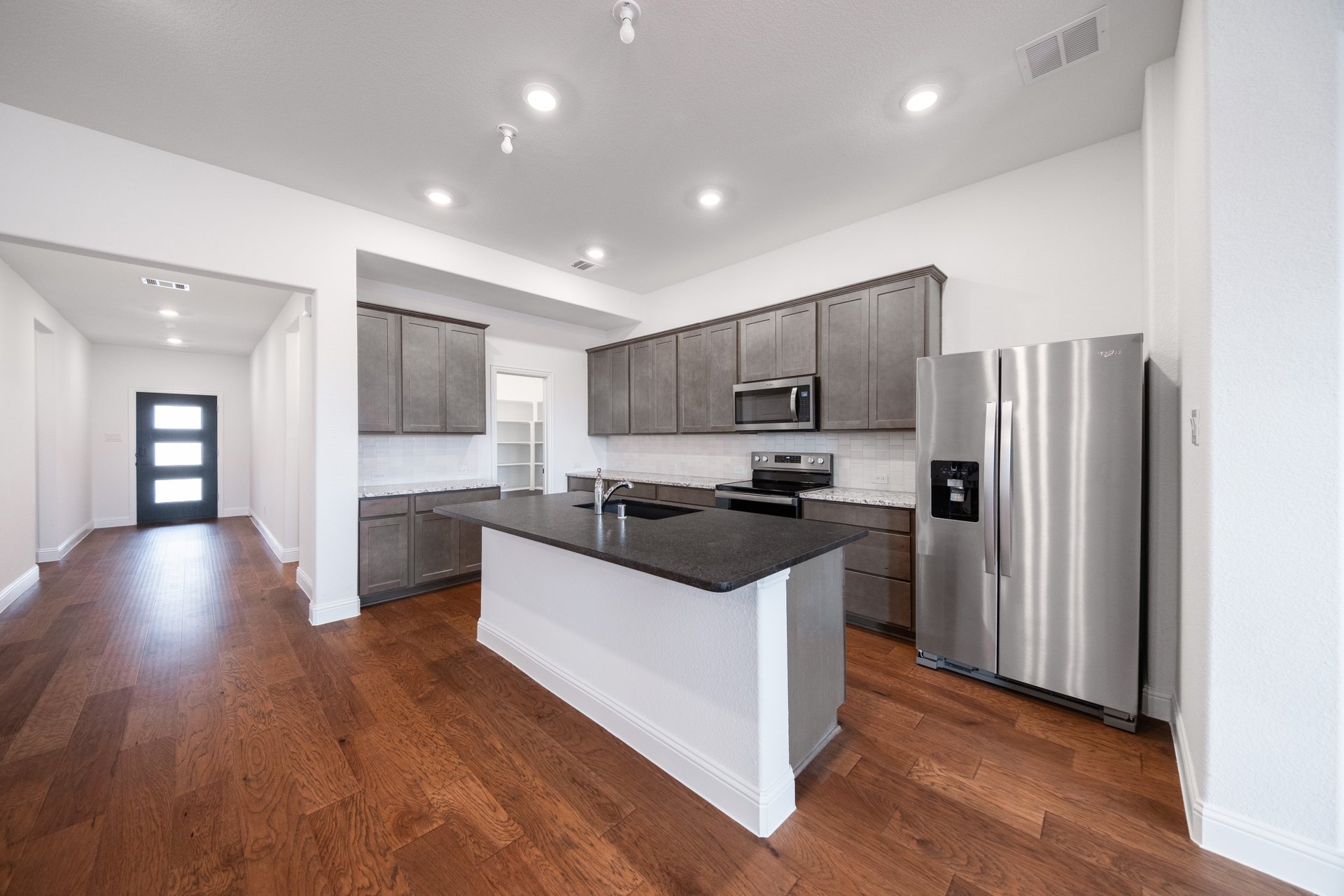 kitchen with large island with dark cabinets 